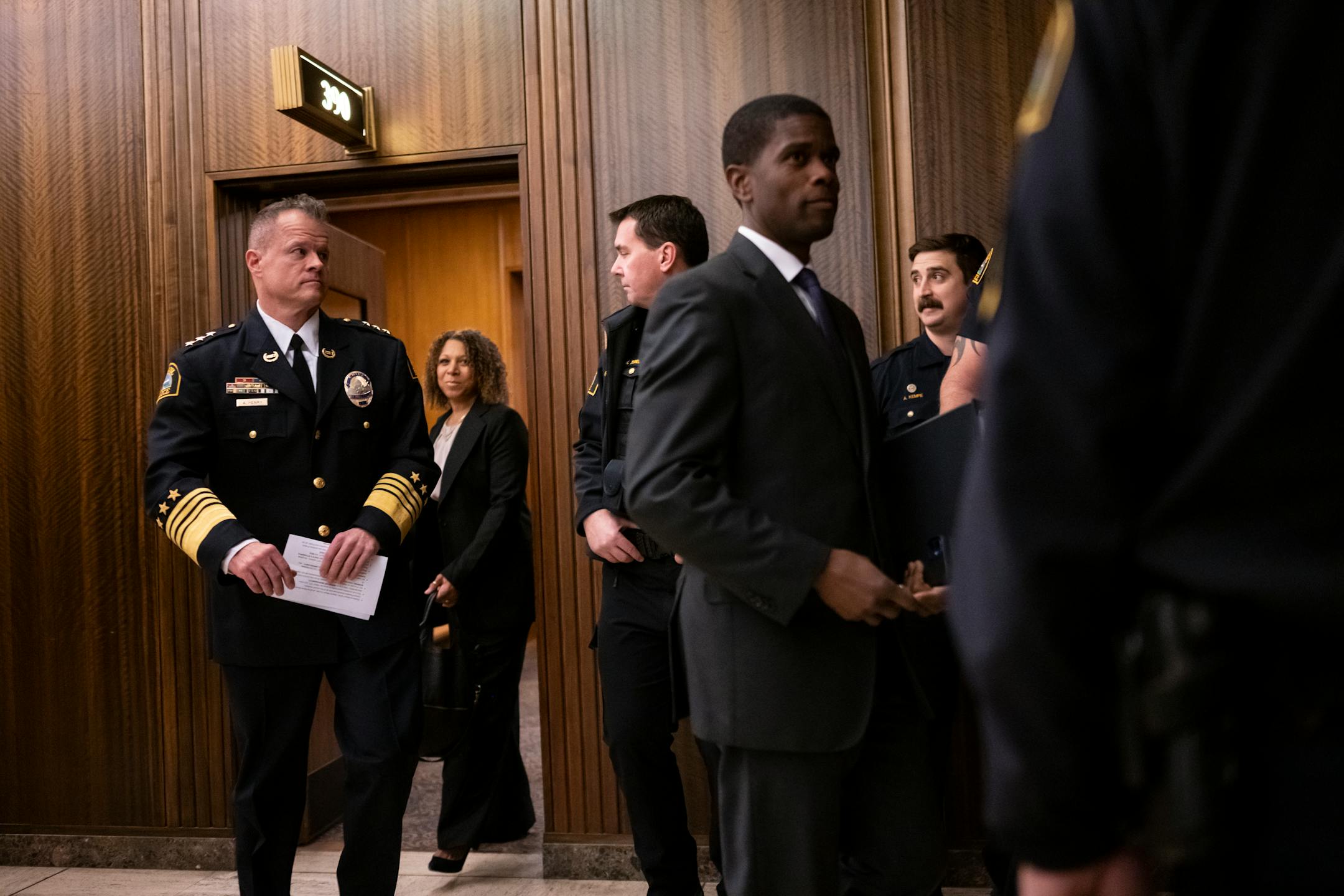 St. Paul Police Commander of Narcotics, Financial Intelligence and Human Trafficking Division Axel Henry and Mayor Melvin Carter emerge from Carter's office before Axel was confirmed as the new police chief by city council Wednesday, Nov. 16, 2022 at St. Paul City Hall in St. Paul, Minn..