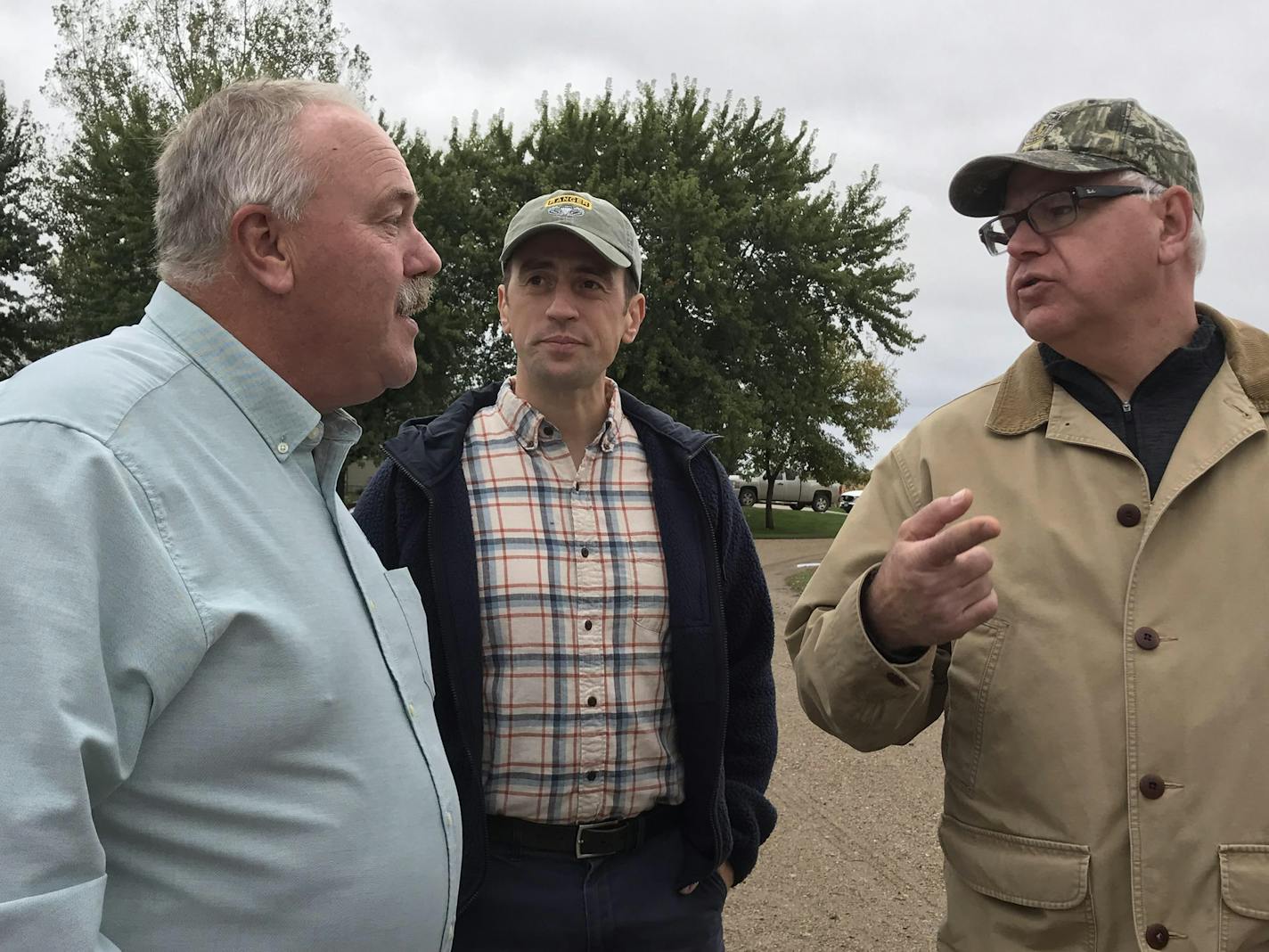 Tim Waibel, left, who farms near Courtland, Minn., discussed the agricultural economy Friday with DFL gubernatorial candidate Tim Walz, right, and Dan Feehan, a Democrat running for Minnesota&#xed;s First District seat in the U.S. House of Representatives.