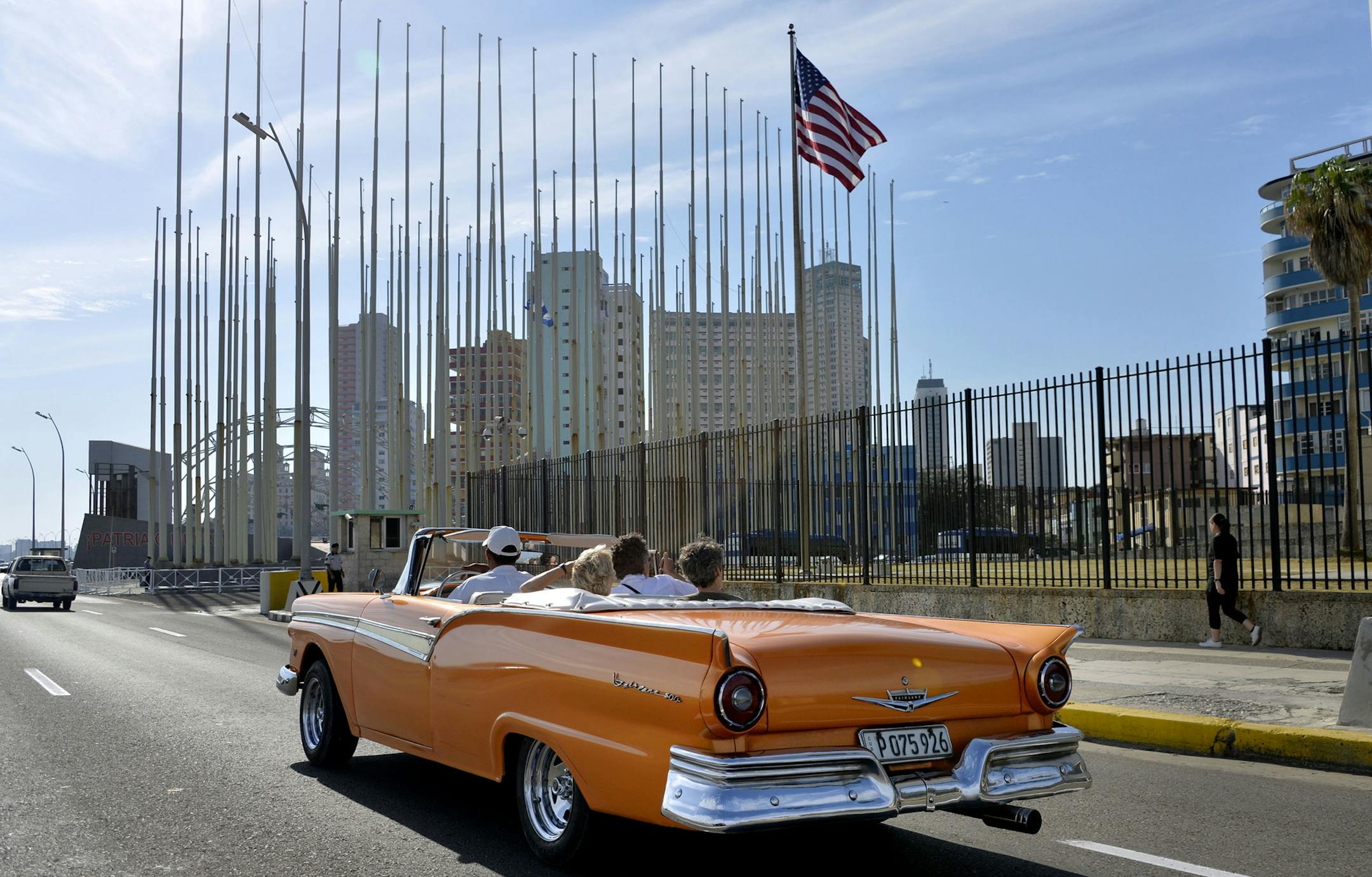 An old car passes in front of the U.S Embassy in Havana, Cuba, on March 17, 2016, prior to a visit by U.S. President Barack Obama.