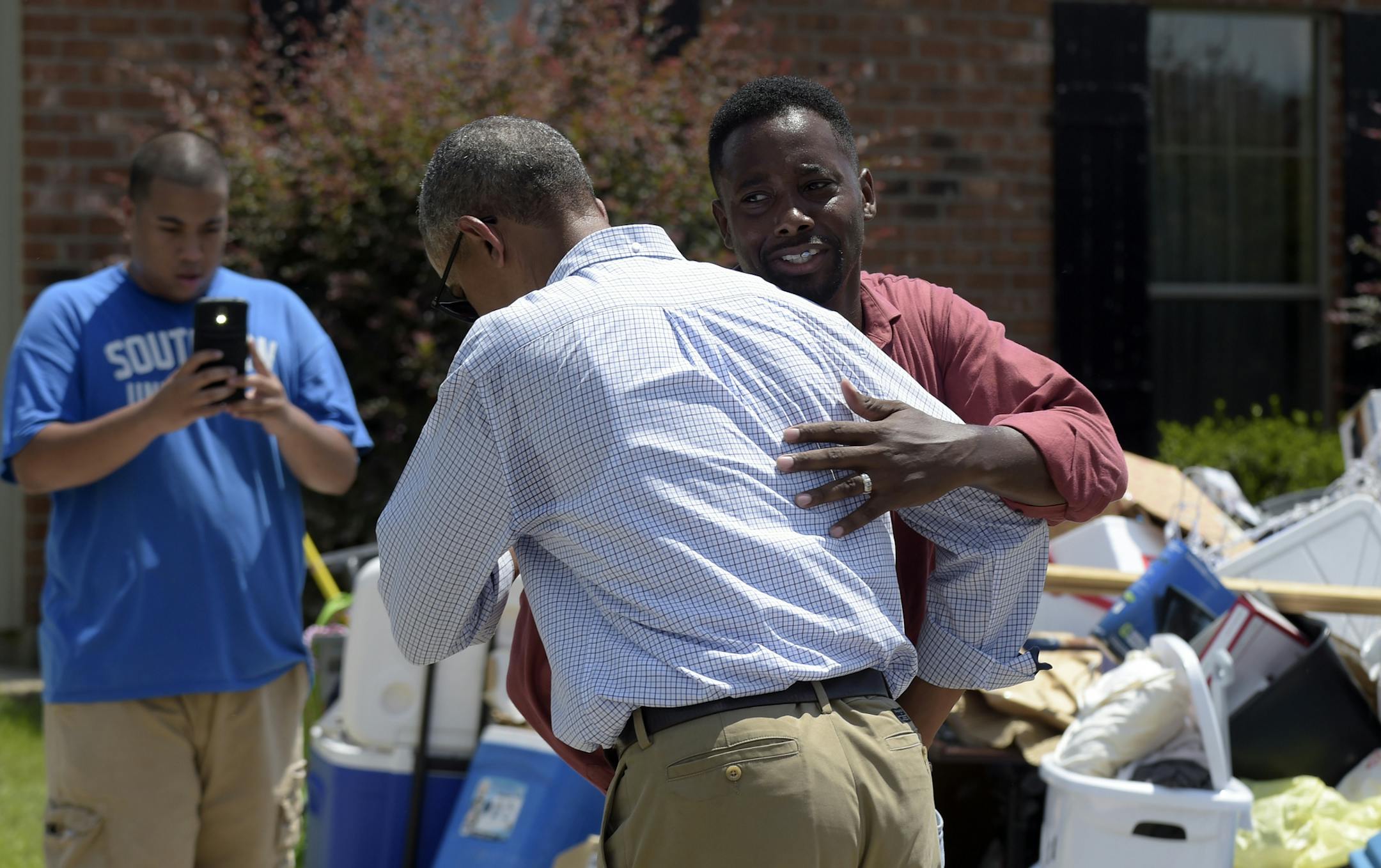 President Barack Obama is greeted as he tours Castle Place, a flood-damaged area of Baton Rouge, La., Tuesday, Aug. 23, 2016. Obama is making his first visit to flood-ravaged southern Louisiana as he attempts to assure the many thousands who have suffered damage to their homes, schools and businesses that his administration has made their recovery a priority. (AP Photo/Susan Walsh)