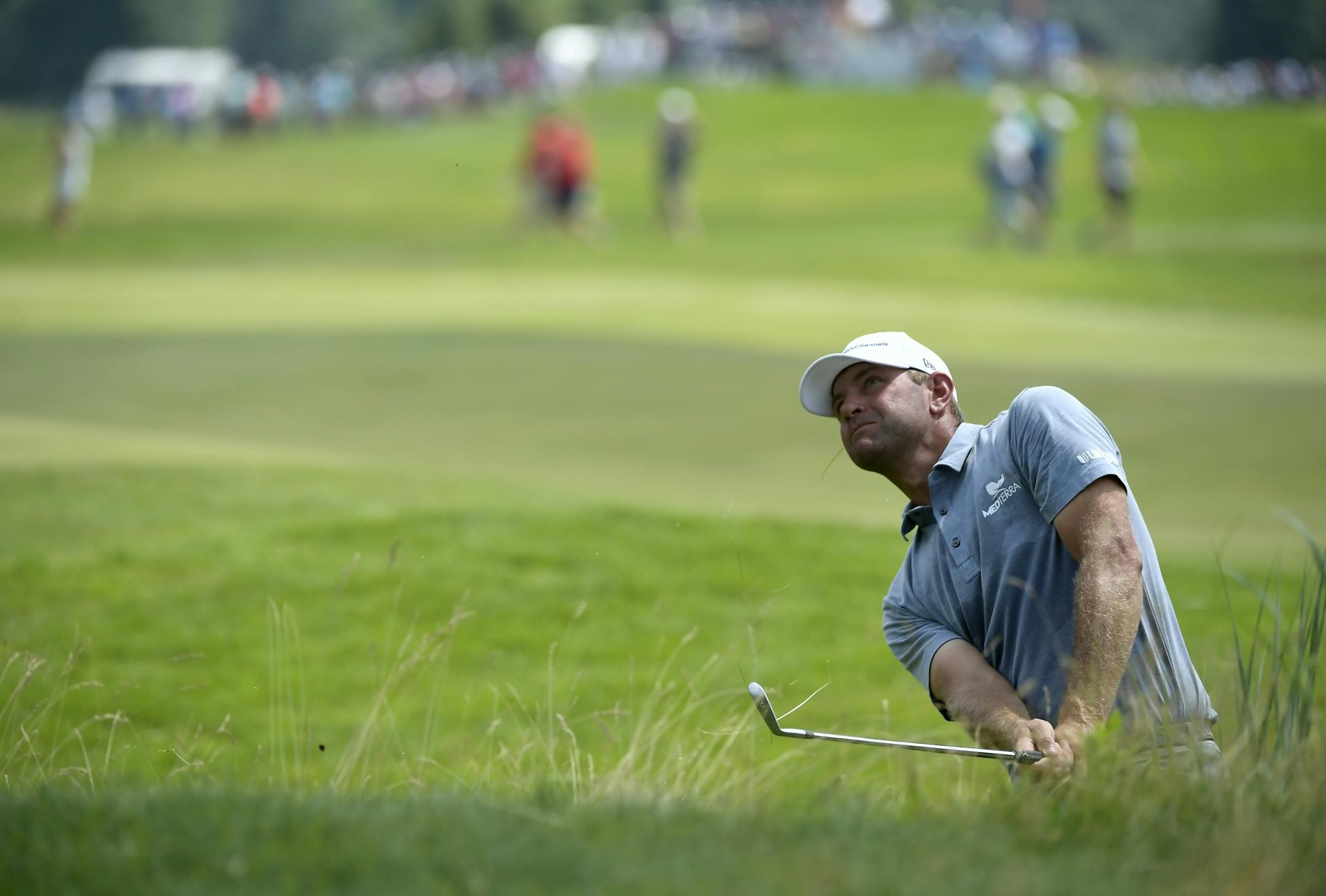 Lucas Glover hit out of the rough on the18th hole during the final day of the 3M Open at TPC Twin Cities.