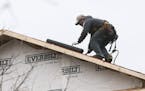 In this Tuesday, Jan. 26, 2016, photo, a man installs a roof on a new home under construction in Atlanta. On Tuesday, Feb. 16, 2016, the National Asso