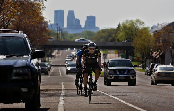 Chuck Hermes rode his bicycle through traffic along Como Ave. during his commute home after work in Minneapolis. A Stillwater resident, Hermes parks h