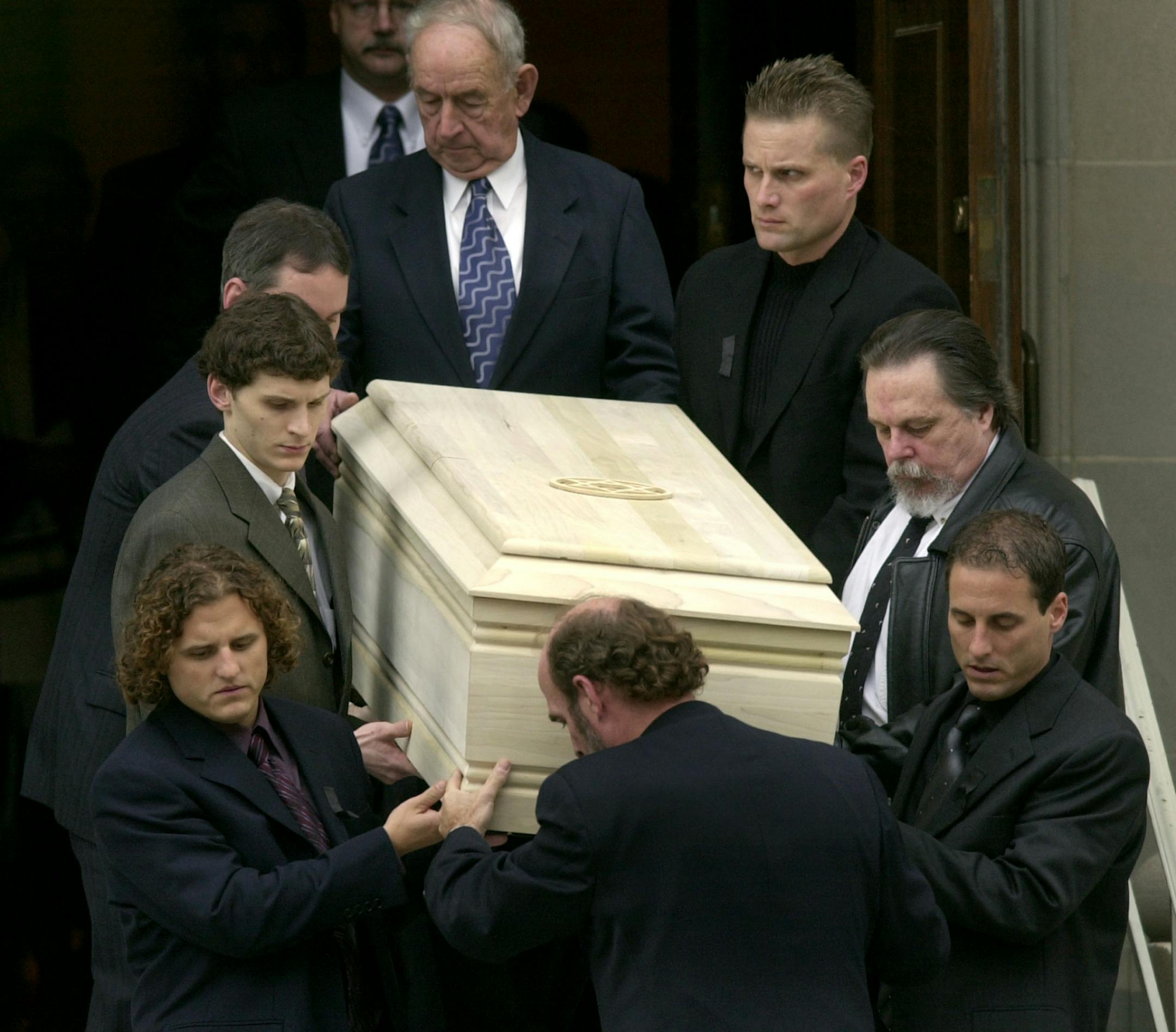 Pall bearers carry the casket of Sen. Paul Wellstone, D-Minn., including Wellstone's sons Mark, lower left, and David, lower right, from a private funeral in Minneapolis, Monday, Oct. 28, 2002.