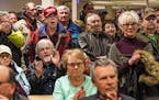 Those in attendance who favored a motion against refugee resettlement stood in the back and made their opinions known. ] Beltrami County is the latest