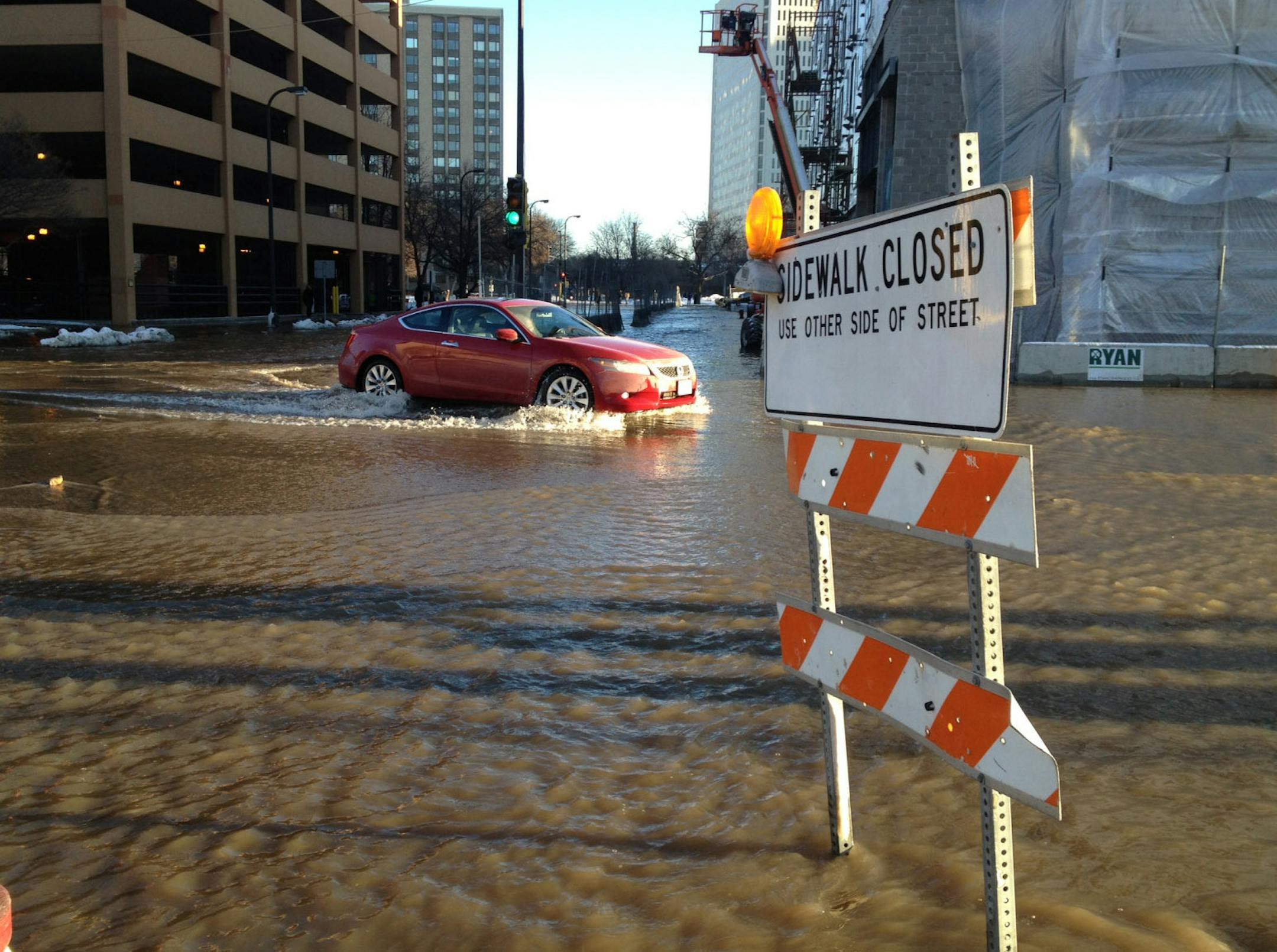 Water floods the street from a water main break at Hennepin Ave. and 2nd St. in downtown Minneapolis Thursday. This photo shows the intersection of 1st Ave. and 2nd St. Photo Kyndell Harkness/Star Tribune kharkness@startribune.com Minneapolis, MN 1/3/2013 (photo taken with iPhone)