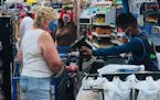 Photo provided by Raphaela Mueller: A couple wearing swastika masks (behind the front customer) made defiant gestures at other shoppers who reacted ne