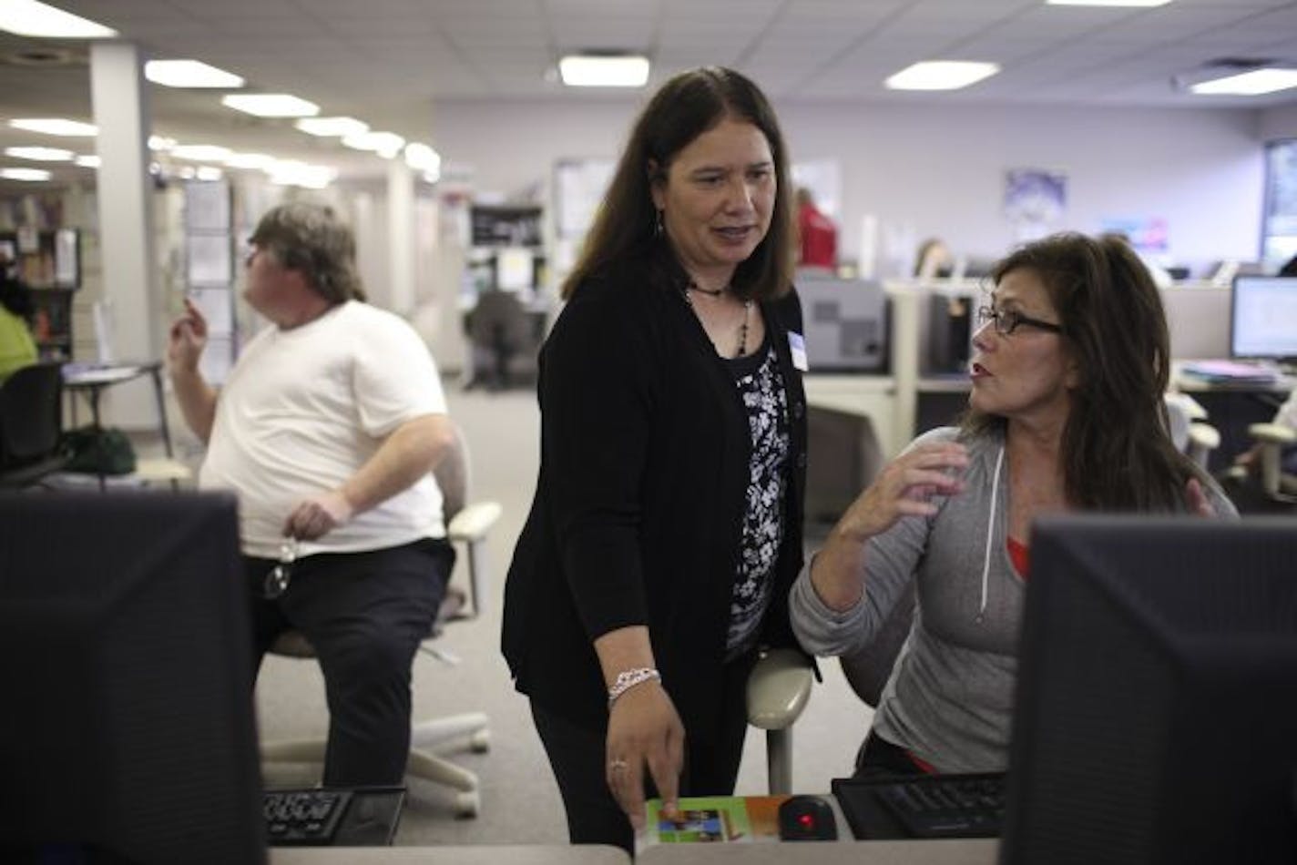 Pat Thiewes, left, showed Barbara Walker how to use software she will need to retool her résumé to make herself more marketable Wednesday afternoon at the Bloomington Workforce Center.