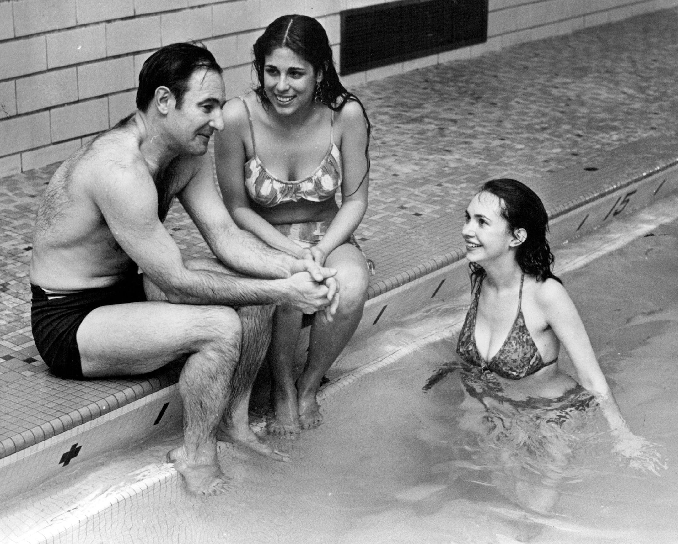 January 1, 1972 Man at work — Jim Klobuchar's offer to work on New Year's Eve caused some skepticism. But he is shown above "at work," discussing with University of Minnesota coed Diane Rothfeder the finer nuances of the "Water Whistle" concert presented Friday night at the Midway YMCA pool. Jim failed to introduce the other music lover (right) to the photographer, but he did spend some time in the water hearing the music. December 31, 1971 William Seaman, Minneapolis Star Tribune