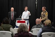 St. Croix Country Republican Party Chairman Matthew Rust, center, called on a man with a question for St. Croix County administrator Ken Witt, left, a