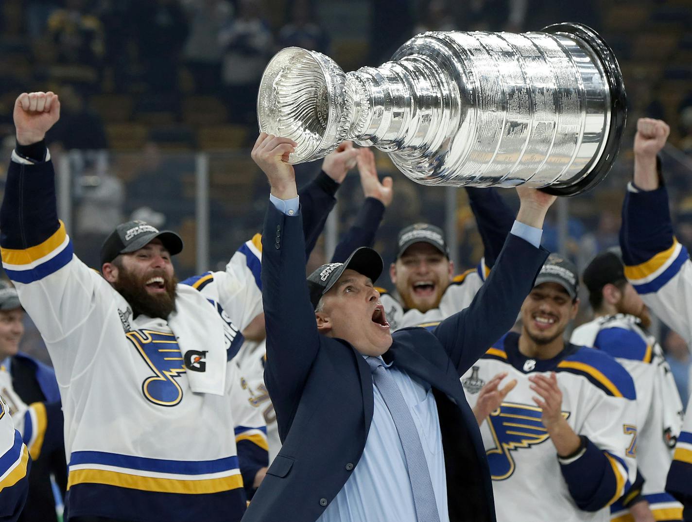 FILE - In this June 12, 2019, file photo, St. Louis Blues head coach Craig Berube carries the Stanley Cup after the Blues defeated the Boston Bruins in Game 7 of the NHL Stanley Cup Final, in Boston. The NHL 2019-20 regular season begins Oct. 2. (AP Photo/Michael Dwyer)