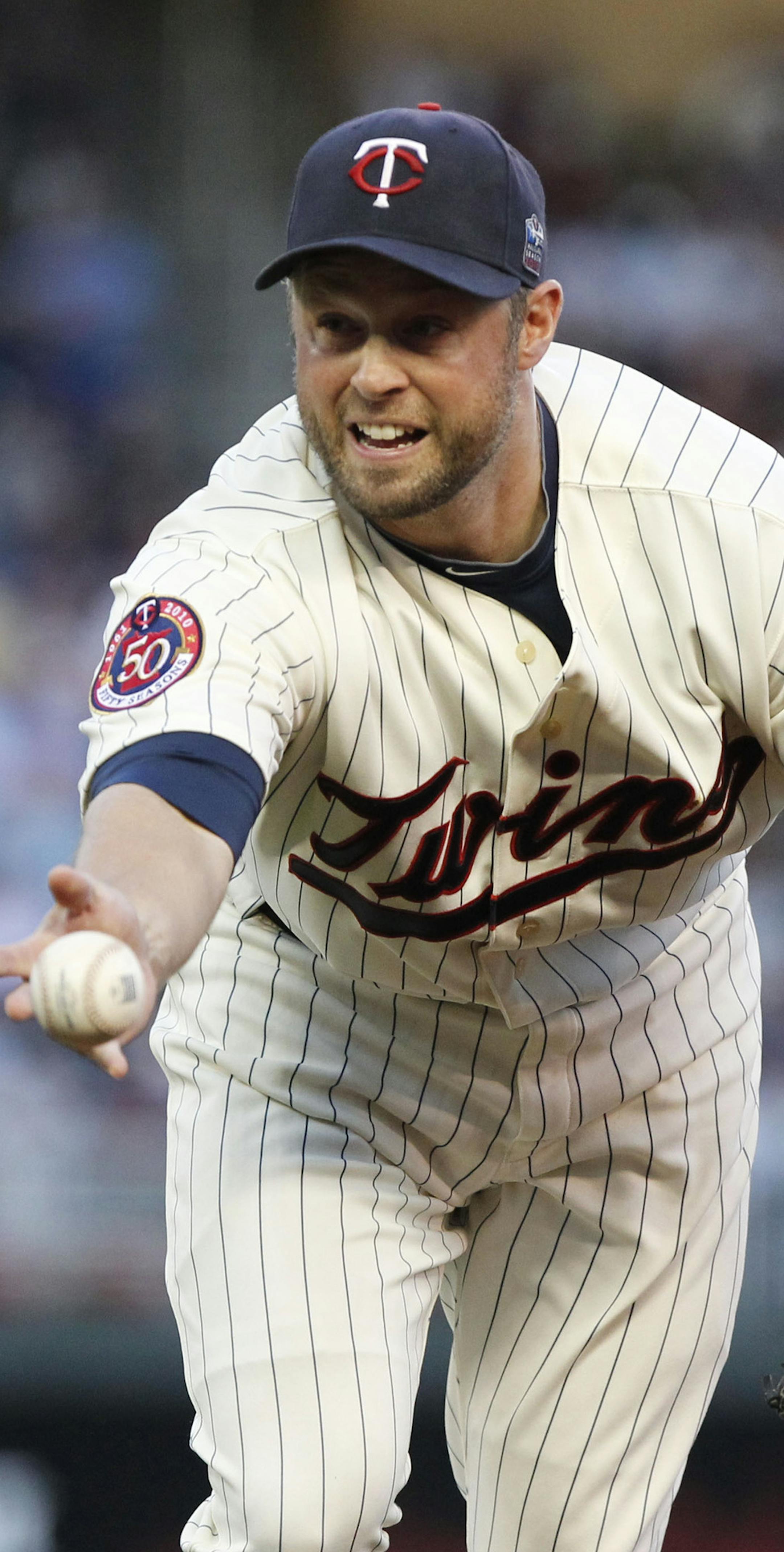 CARLOS GONZALEZ • cgonzalez@startribune.com October 7, 2010 – Minneapolis, Minn – Target Field – MLB – ALDS – Game 2 - Minnesota Twins vs. New York Yankees ] Twins Michael Cuddyer tosses a ground ball hit by Lance Berkman to Carl Pavano for the out in the third inning Thursday at Target Field. ORG XMIT: MIN2013071500564203