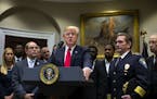 President Donald Trump with Chief Paul Cell, of the International Association of Chiefs of Police, left, during an announcement of his support for a c