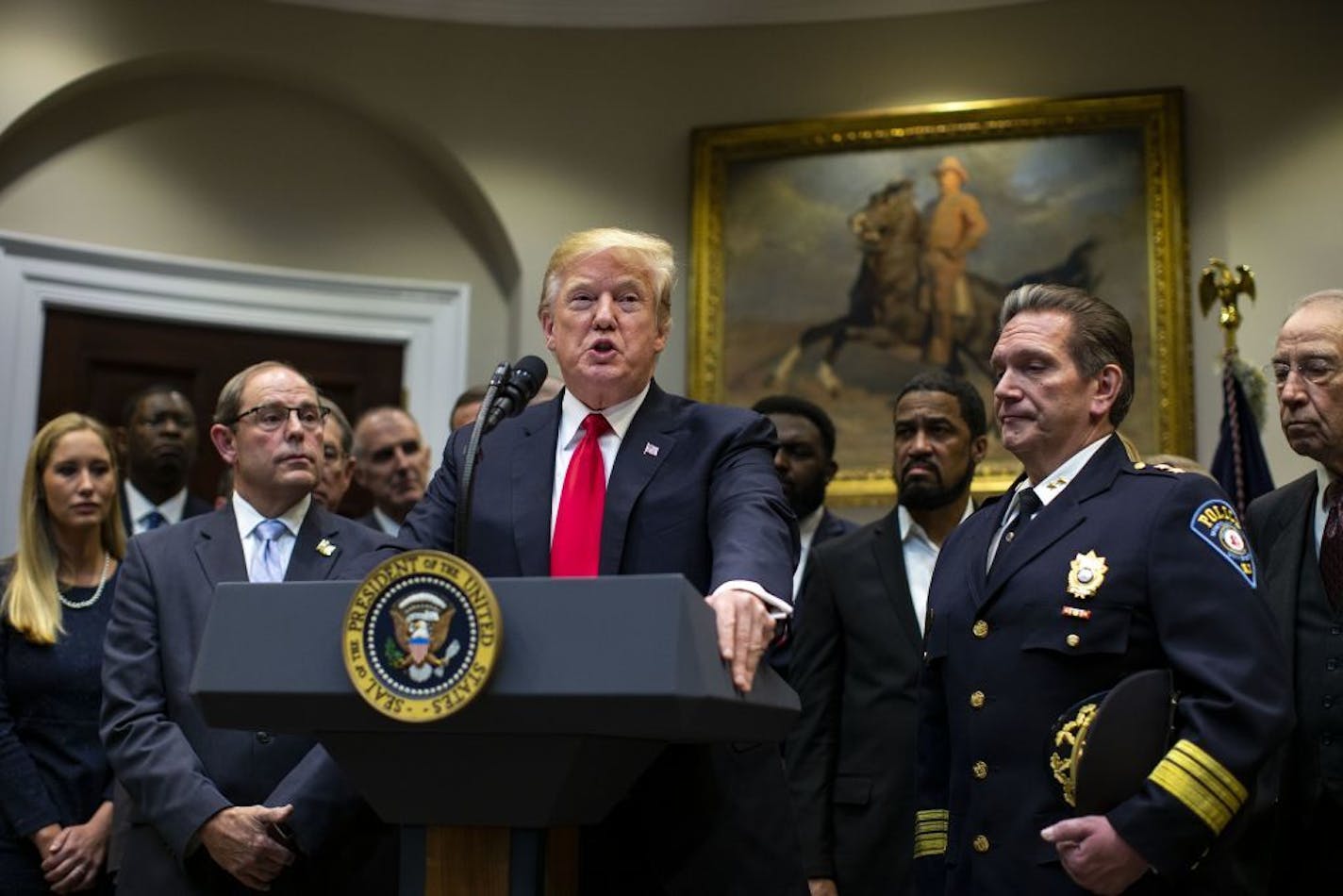 President Donald Trump with Chief Paul Cell, of the International Association of Chiefs of Police, left, during an announcement of his support for a criminal justice reform bill, called the First Step Act, at the White House in Washington, Nov. 14, 2018. Trump on Nov. 15 blasted the special counsel team, calling it a "disgrace" to the country in an early Twitter post and renewed previous attacks on the investigation, calling it, "A TOTAL WITCH HUNT LIKE NO OTHER IN AMERICAN HISTORY! The fresh ba