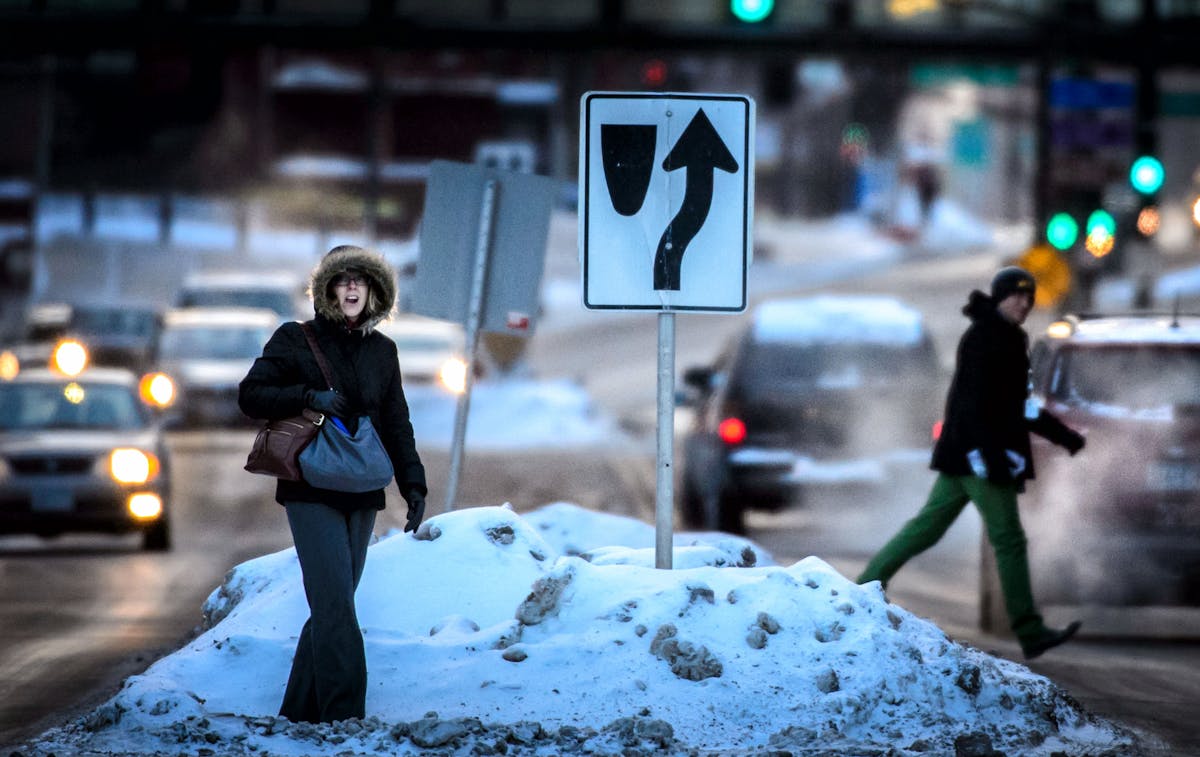 People walked, jogged and sprinted over a pile of snow and across 7th Street in St. Paul this winter.