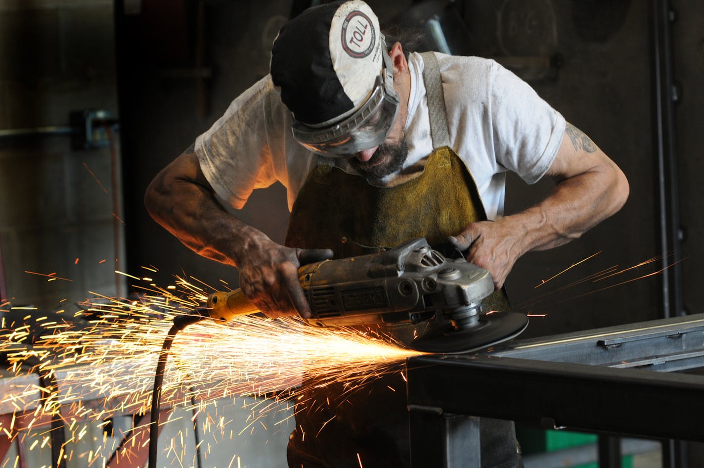 A worker uses a grinder on a welding project at Code Welding in Blaine, Minn. [Star Tribune file photo]