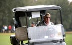 John Daly drives a cart to the ninth green during the first round of the Father Son Challenge golf tournament Saturday, Dec. 15, 2018, in Orlando, Fla
