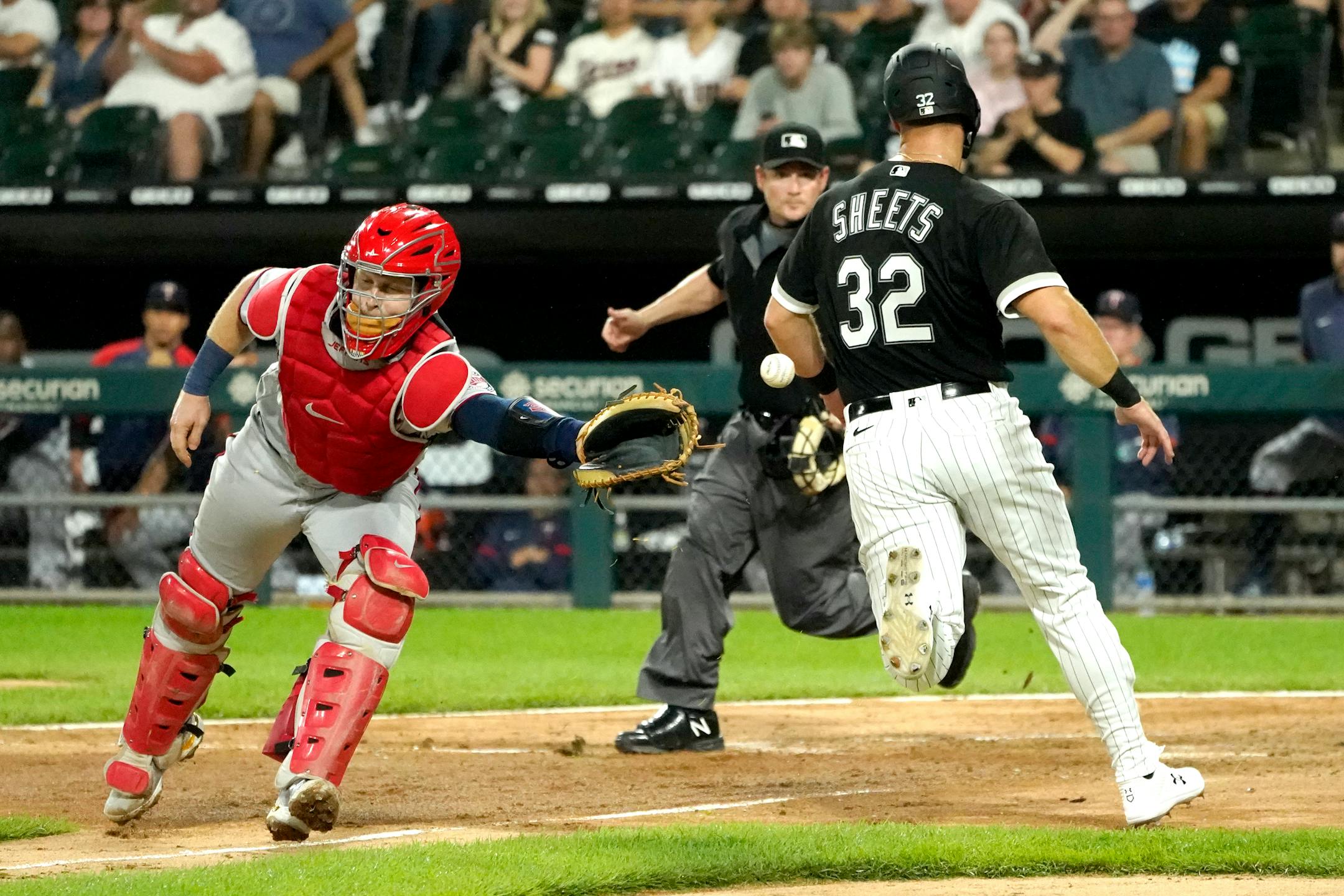Chicago White Sox's Gavin Sheets (32) scores past Minnesota Twins catcher Ryan Jeffers, off a hit by Danny Mendick during the fifth inning of a baseball game Tuesday, June 29, 2021, in Chicago. (AP Photo/Charles Rex Arbogast)