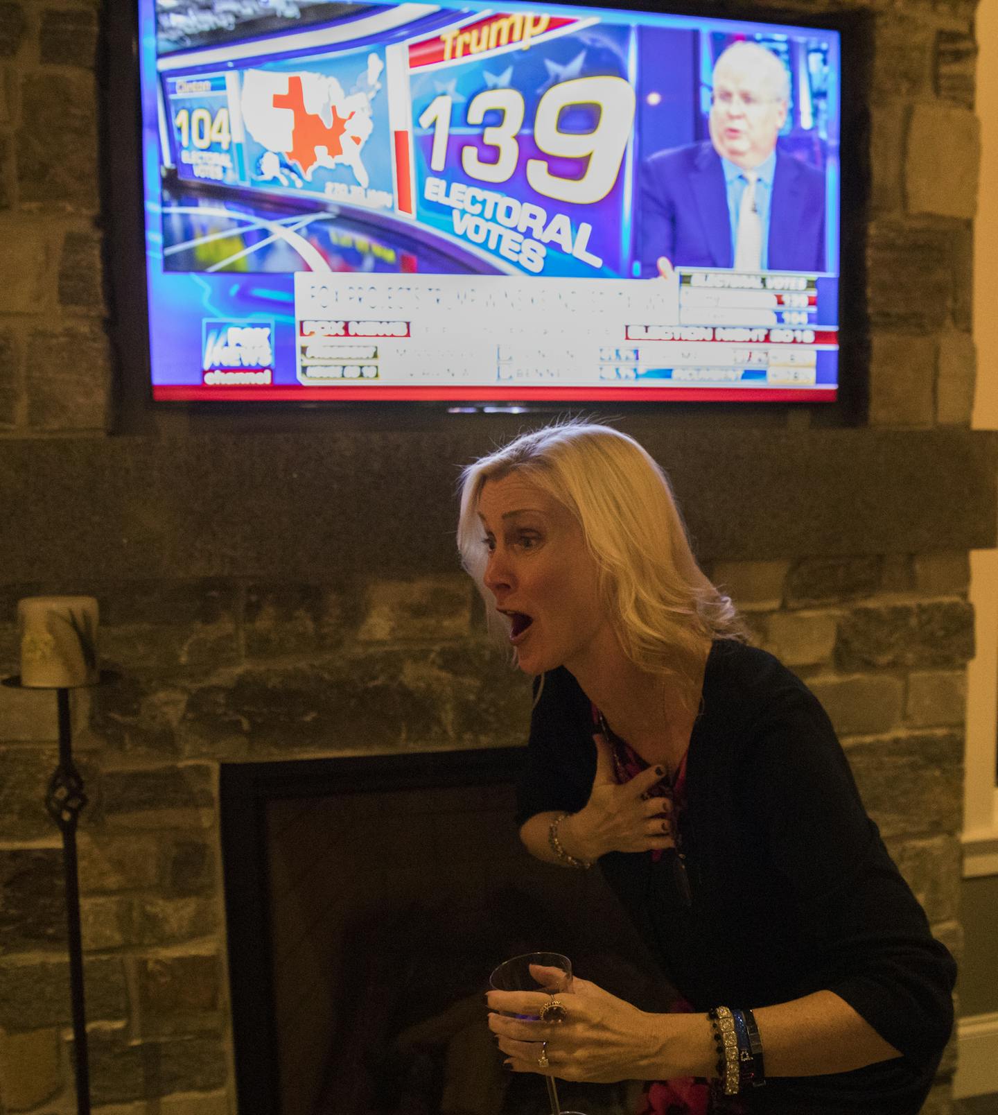 Mary Susan Rehrer celebrates Trump being ahead in early polls in Minnesota. ] (Leila Navidi/Star Tribune) leila.navidi@startribune.com BACKGROUND INFORMATION: An election results watch party for Donald Trump supporters at the home of Sheri Auclair in Wayzata on Tuesday, November 8, 2016.