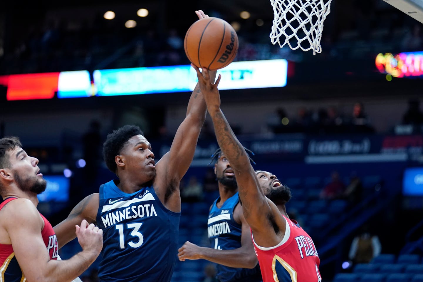 New Orleans Pelicans forward Naji Marshall goes to the basket against Minnesota Timberwolves forward Nathan Knight (13) in the second half of an NBA basketball game in New Orleans, Monday, Nov. 22, 2021. The Timberwolves won 110-96.(AP Photo/Gerald Herbert)