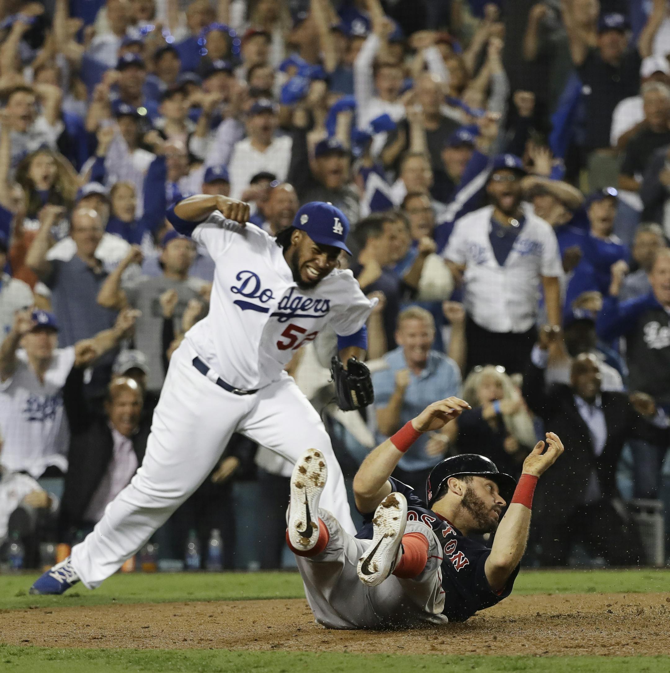 Los Angeles Dodgers pitcher Pedro Baez reacts after Boston Red Sox's Ian Kinsler was tagged out at home plate while trying to score on a sacrifice fly by Eduardo Nunez during the 10th inning in Game 3 of the World Series baseball game on Friday, Oct. 26, 2018, in Los Angeles. (AP Photo/David J. Phillip)