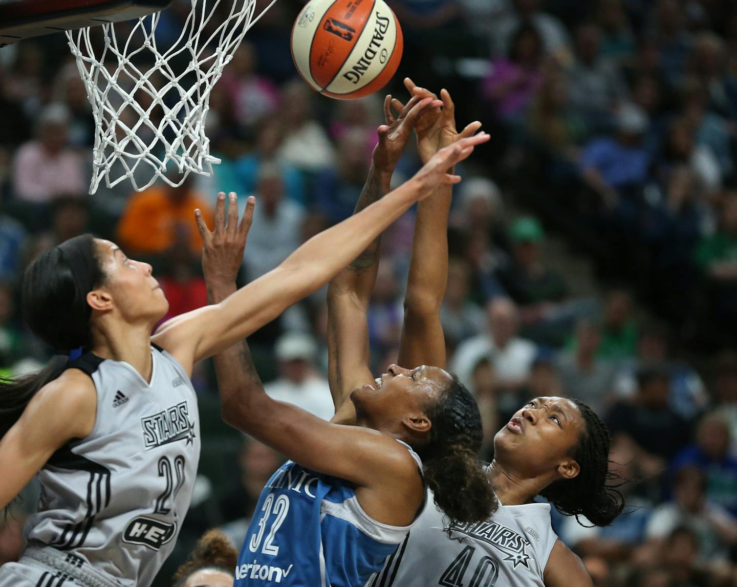 Minnesota Lynx forward Rebekkah Brunson (32) was double teamed by San Antonio Stars center Isabelle Harrison (20) left and Kayla Alexander (40)