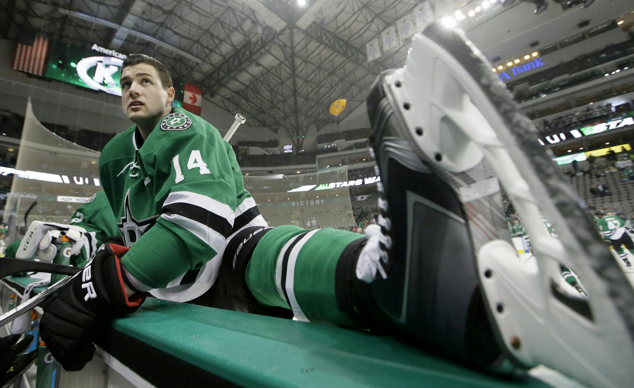 Dallas Stars left wing Jamie Benn (14) stretches during warm-ups before of an NHL hockey game against the New Jersey Devils Friday, March 4, 2016, in Dallas. (AP Photo/LM Otero)