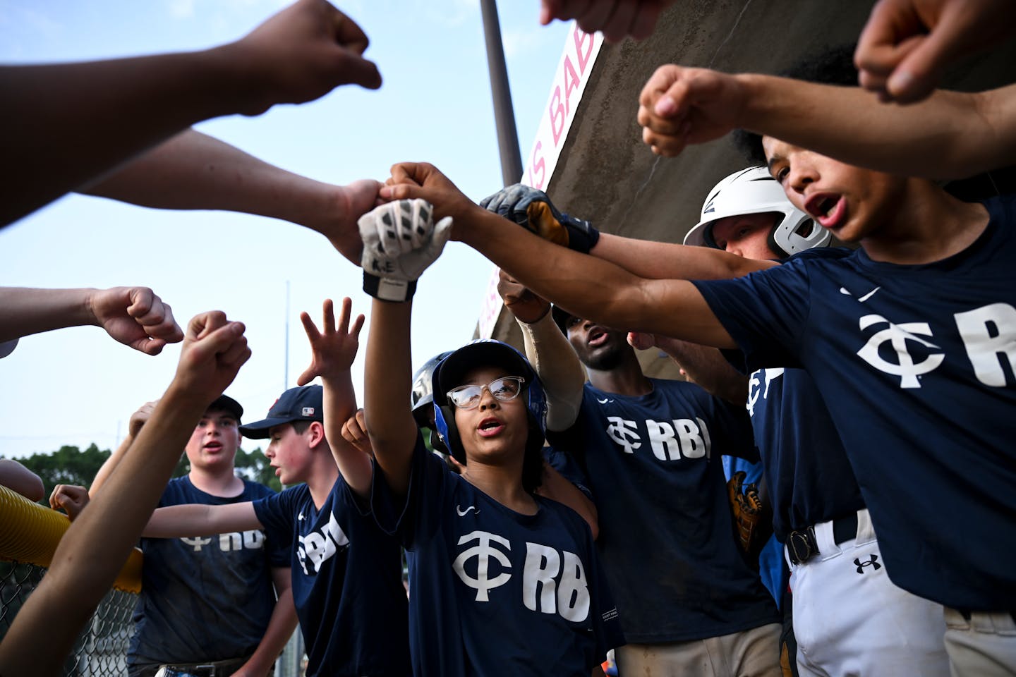 The Midway Blazers, including Kylee Erb, center, huddle up before taking defense for the last time during a U15 baseball game between the Midway Blazers and St. Agnes Thursday, June 22, 2023, at East Twins Babe Ruth Field in St. Paul, Minn. ] AARON LAVINSKY • aaron.lavinsky@startribune.com