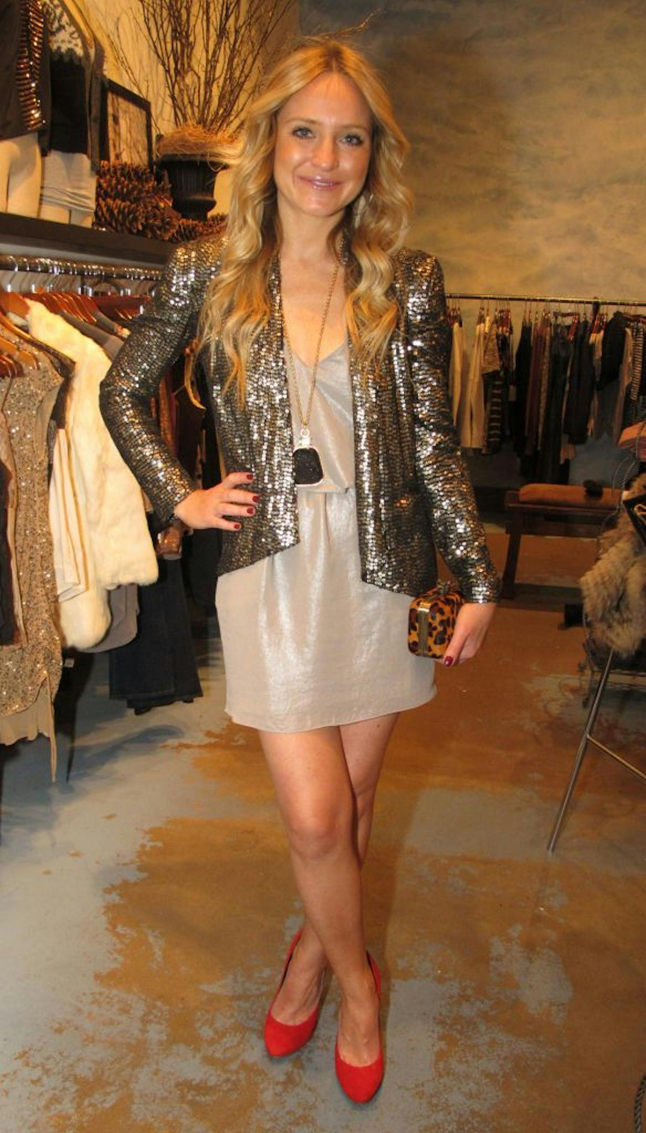 Sacha Martin, owner of Bluebird and Ladyslipper, wears Krisa dress ($160) and Gerard Yosca pendant ($160) from Bluebird Boutique. Rebecca Minkoff sequined jacket ($598), House of Harlow clutch, $220 and Dolce Vita red pumps ($160) from Lady Slipper.