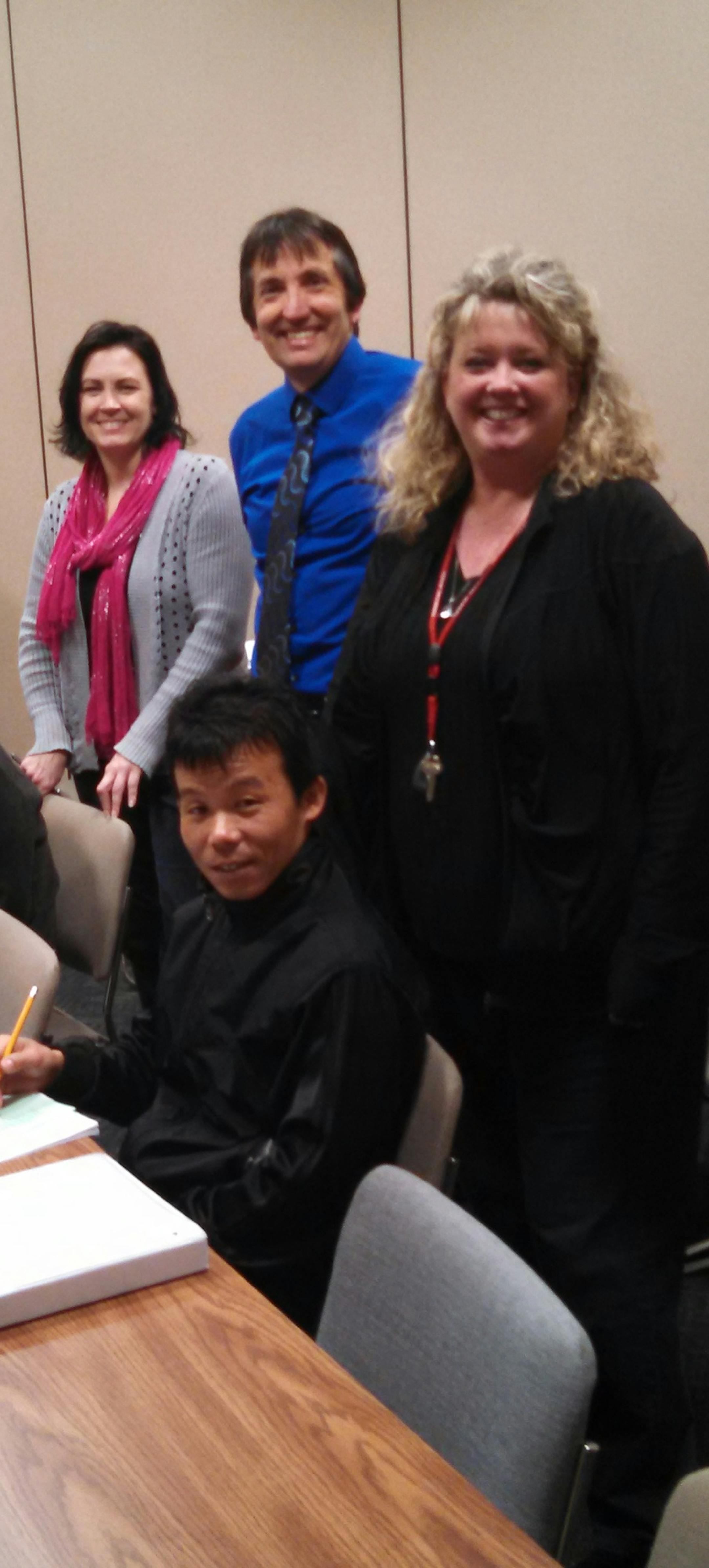 English language students Mohamed Kahin from Somalia and Dilli Rai from Bhutan (seated, left to right) take a break from testing with teachers Angela Nagel (standing, left) and Laurie Burkholder (standing, right) of the Northwest Service Cooperative, which holds classes at Northland Community and Technical College in East Grand Forks. Between the teachers stands Brian Huschle, Northlandís East Grand Forks campus dean.