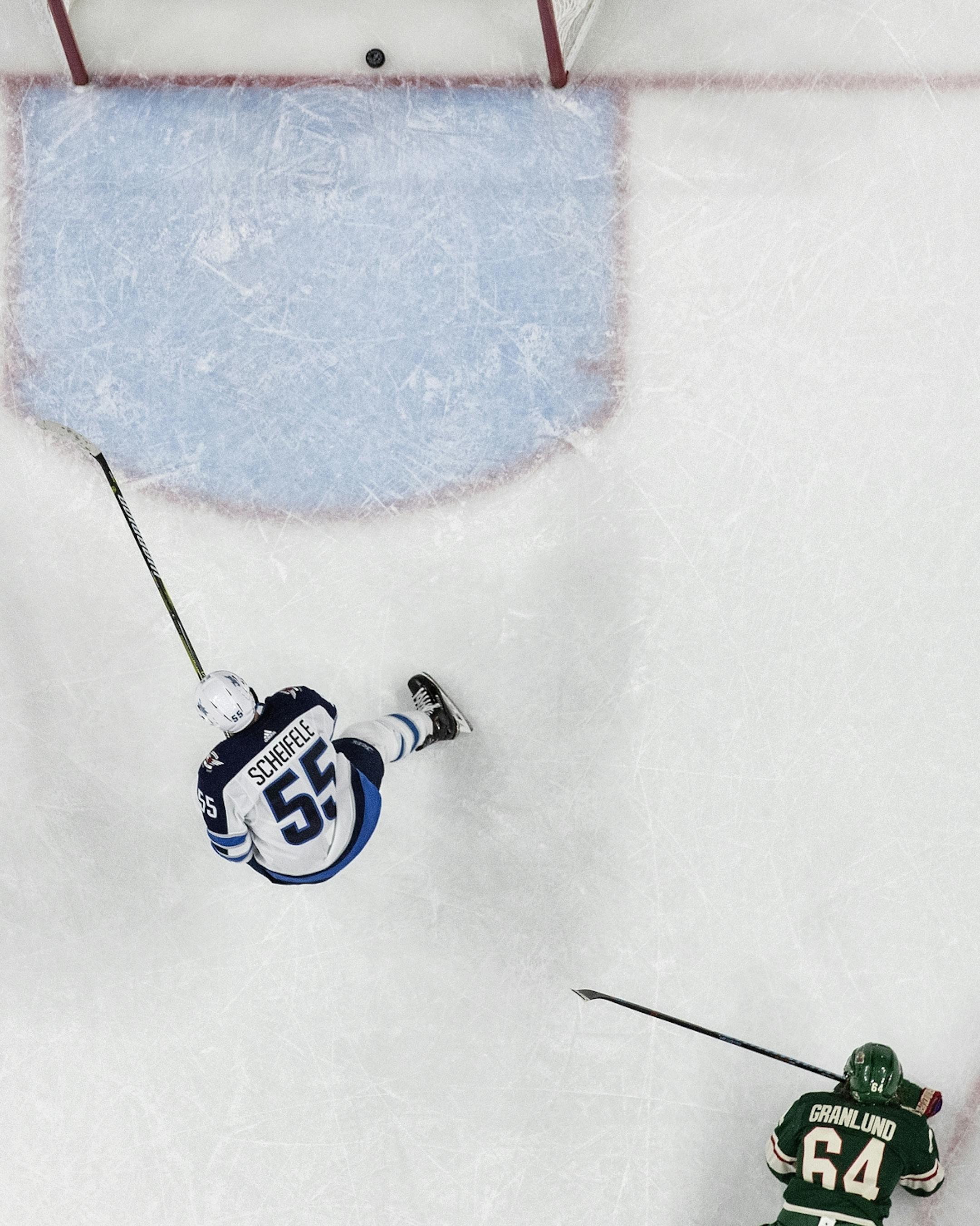 Mark Scheifele (55) broke away from Mikael Granlund (64) to score an empty net goal in the third period.