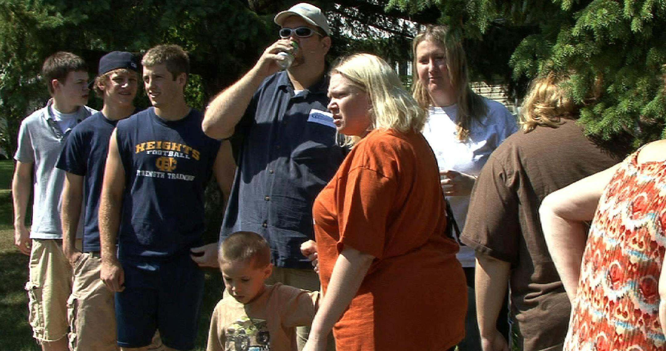 Onlookers gather Friday at the scene of a fire and murder at a house in Columbia Heights.