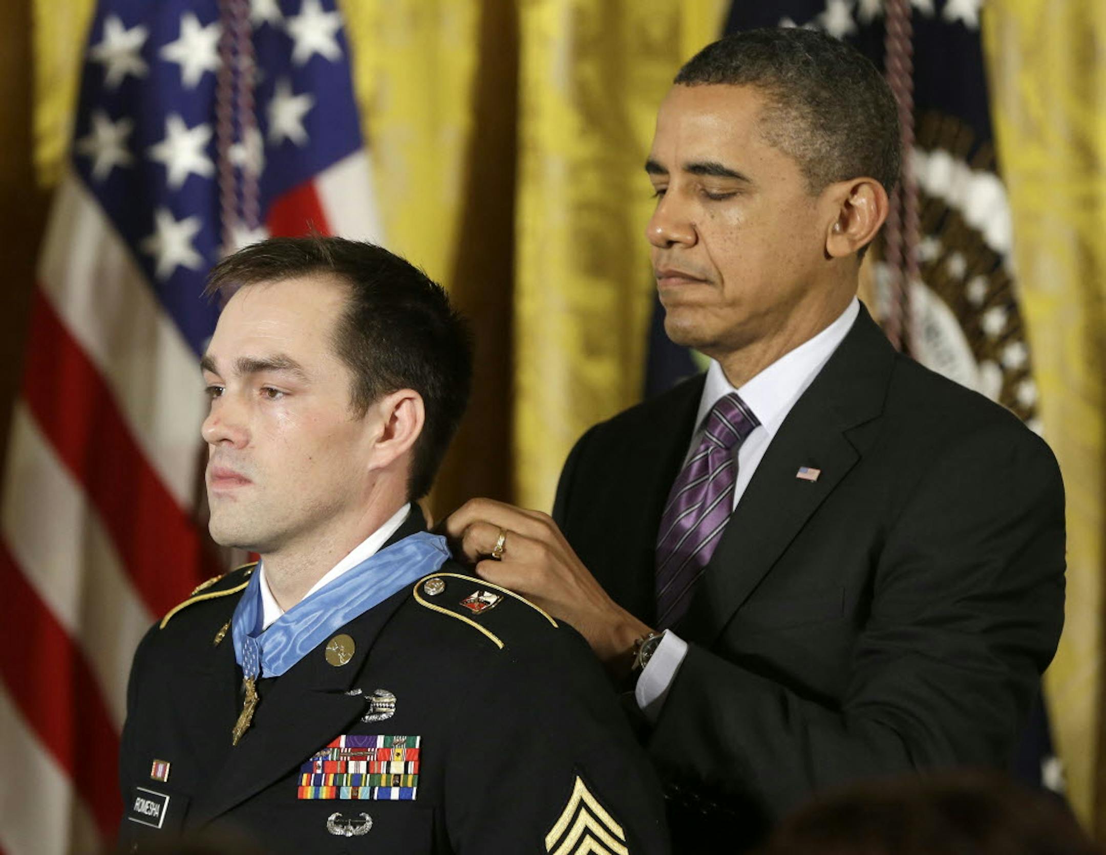 President Barack Obama bestows the Medal of Honor on retired Staff Sgt. Clinton Romesha for conspicuous gallantry during a daylong attack by hundreds of fighters on Combat Outpost Keating in Afghanistan.