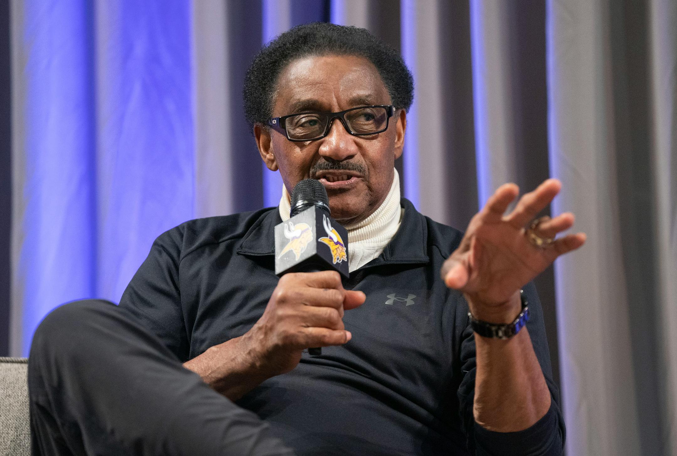 Chuck Foreman, a former Minnesota Vikings running back, answers questions on stage during a Vikings fan rally.
