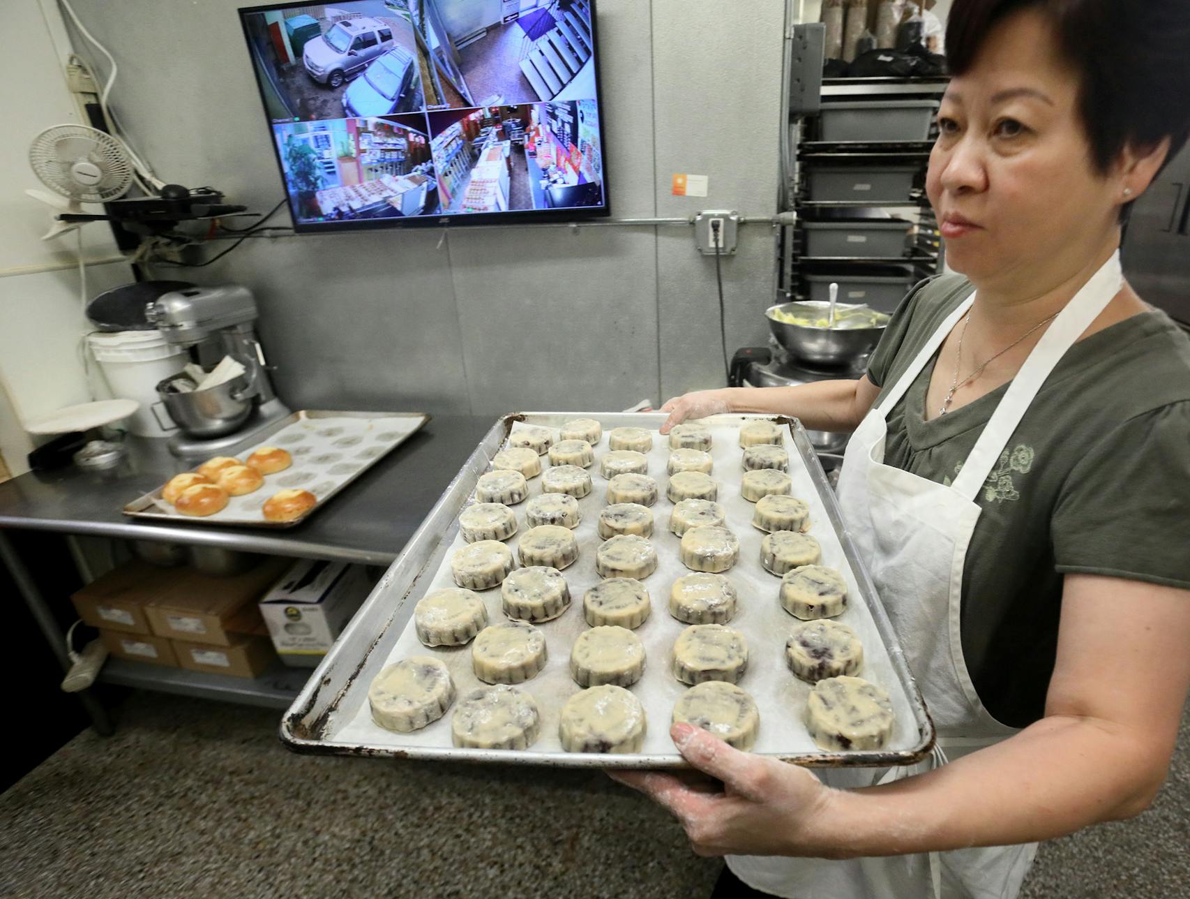 Pauline Kwan made mooncakes ahead of the lunar calendar harvest holiday that begins on Monday. Mooncakes are a specialty at the Mid-Autumn Festival and this is one of the only places in the Twin Cities where they are made. Here, Kwan, who has been making mooncakes for 35 years, with a batch of mini mooncakes ready for the oven at Keefer Court Bakery and Cafe Wednesday, Sept. 18, 2018, in Minneapolis, MN.] DAVID JOLES • david.joles@startribune.com Michelle Kwan is taking over the running of Keefer Court Bakery and Cafe from her parents. Her father was known as the fortune cookie king of the Twin Cities, supplying nearly all the local restaurants with them. According to legend, Han Chinese revolutionaries hid a message of war on the day of the Mid-Autumn Festival inside baked cakes and distributed them to the masses in order to deceive their Mongolian overlords back in the Yuan Dynasty.**Pauline Kwan,cq