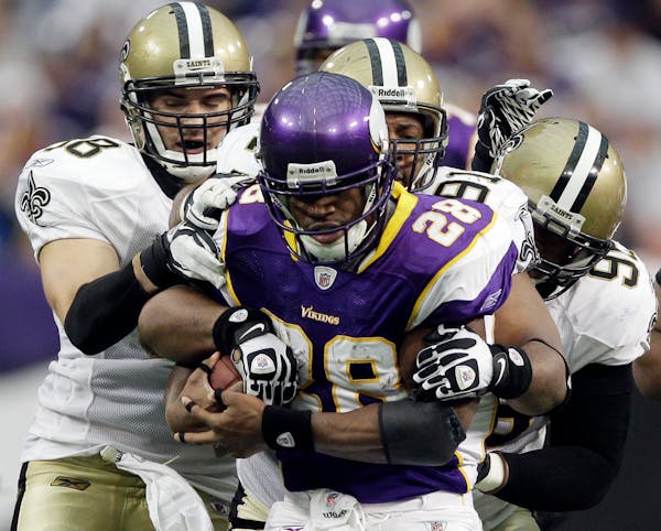 Vikings running back Adrian Peterson, trying to gain extra yardage against the Saints, is considered by many to be the NFL's best running back, but th