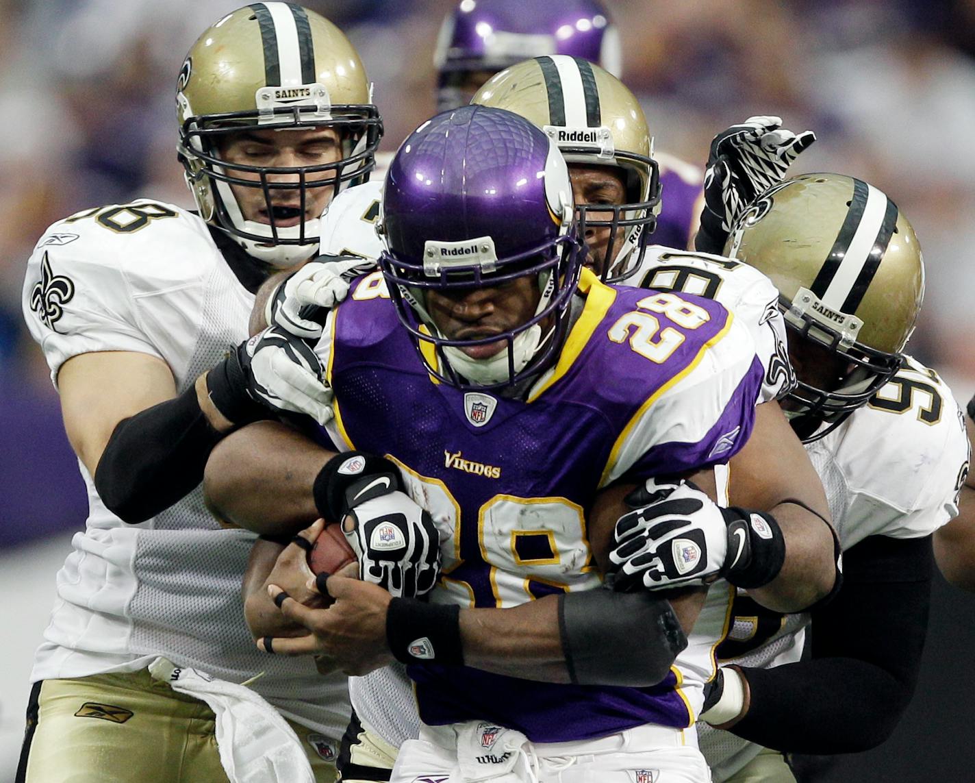 Vikings running back Adrian Peterson, trying to gain extra yardage against the Saints, is considered by many to be the NFL's best running back, but the Vikings have a grand total of one playoff victory in his career.