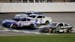 Kyle Larson (5) crosses the finish line milliseconds in front of Chris Buescher (17) for the win during a NASCAR Cup Series auto race at Kansas Speedw