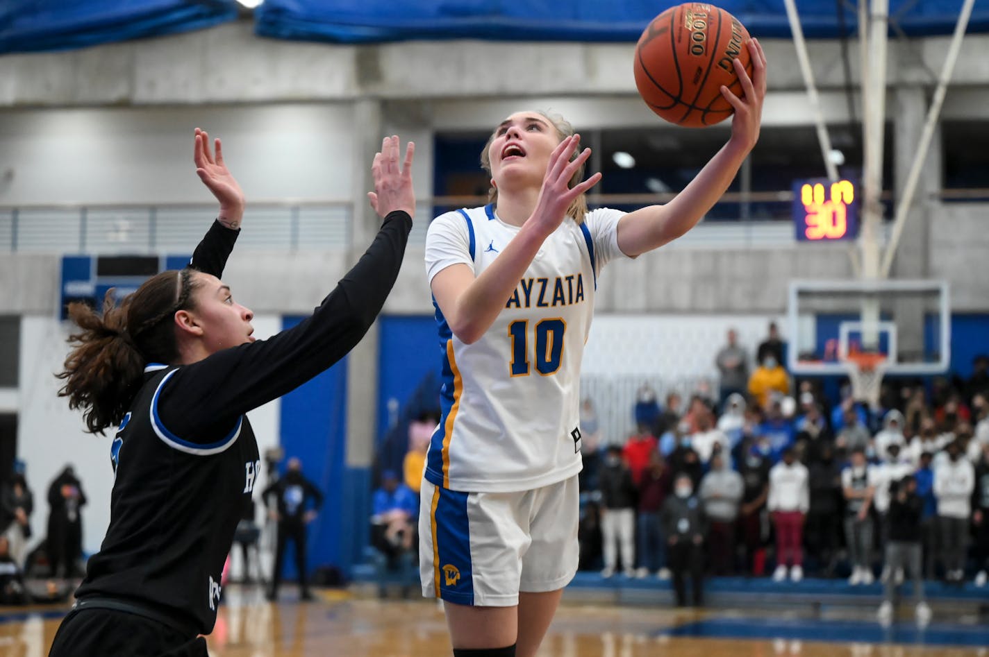 Hopkins guard Amaya Battle (5) defends against a layup attempt by Wayzata forward Mara Braun (10) during the second half of a girls' basketball section final Thursday, March 10, 2022 between Hopkins and Wayzata at Hopkins High School in Hopkins, Minn. ] AARON LAVINSKY • aaron.lavinsky@startribune.com ORG XMIT: MIN2203102142120183