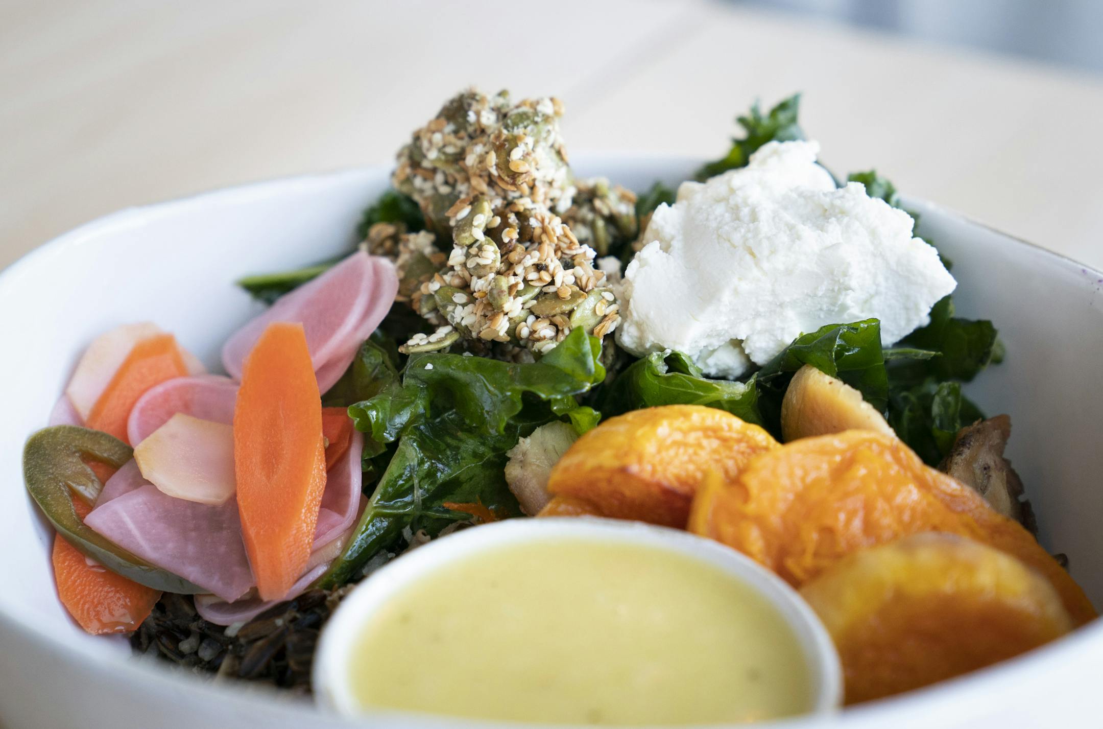 The "Market Chicken" bowl with organic chicken, Red Lake Nation wild rice, roasted roots, kale, goat cheese and toasted seeds at Brim in Minneapolis, Minn., on Thursday, January 24, 2019. ] RENEE JONES SCHNEIDER ¥ renee.jones@startribune.com