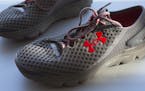 FILE - In this Monday, Jan. 4, 2016, file photo, a pair of Under Armour SpeedForm Gemini 2 Record Equipped running shoes, containing an embedded chip 
