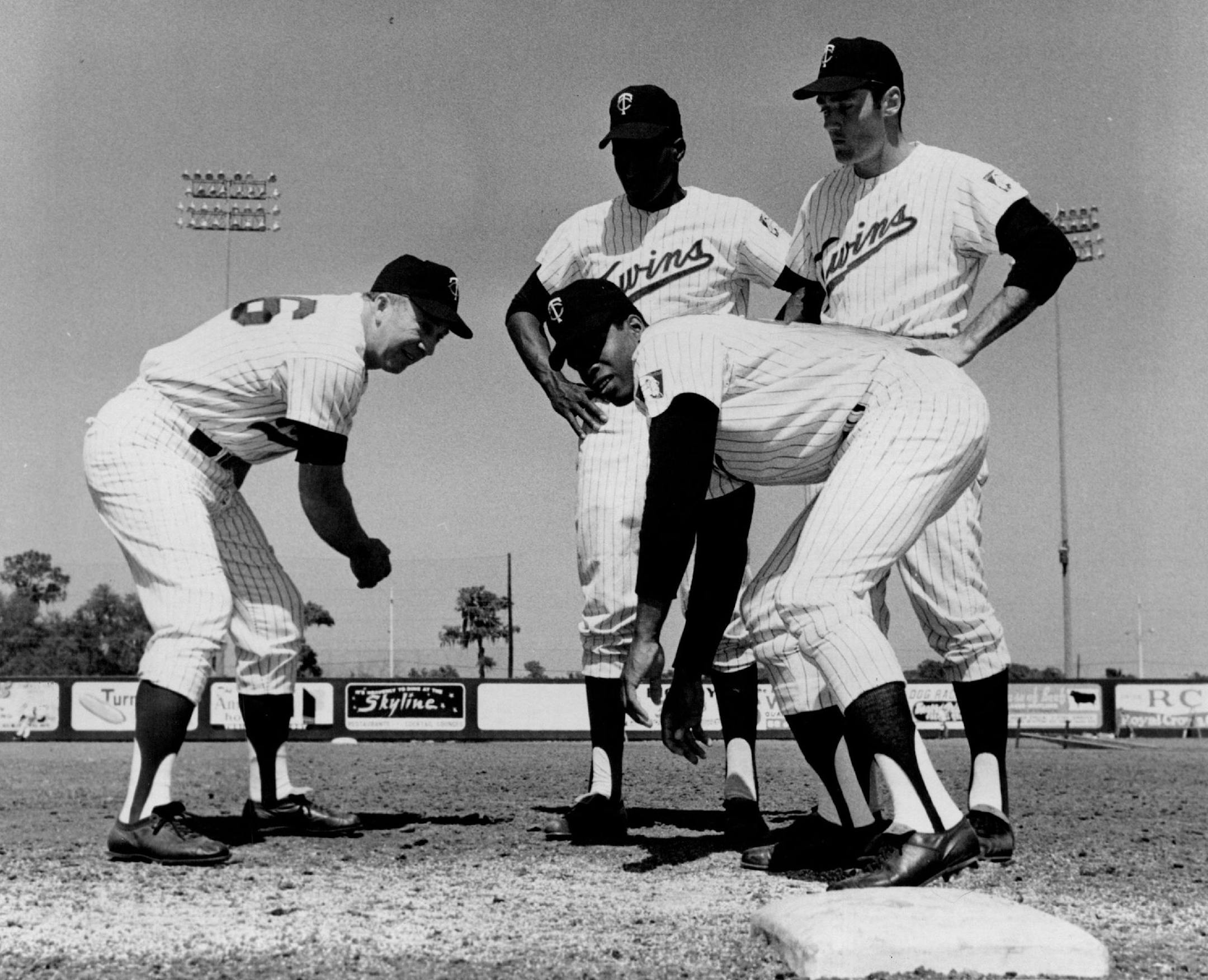 1968: Twins' Coach George Case Demonstrated a leaning lead to Rod Carew, on base, Herman Hill, and Ted Uhlaender. (Star Tribune File Photo)