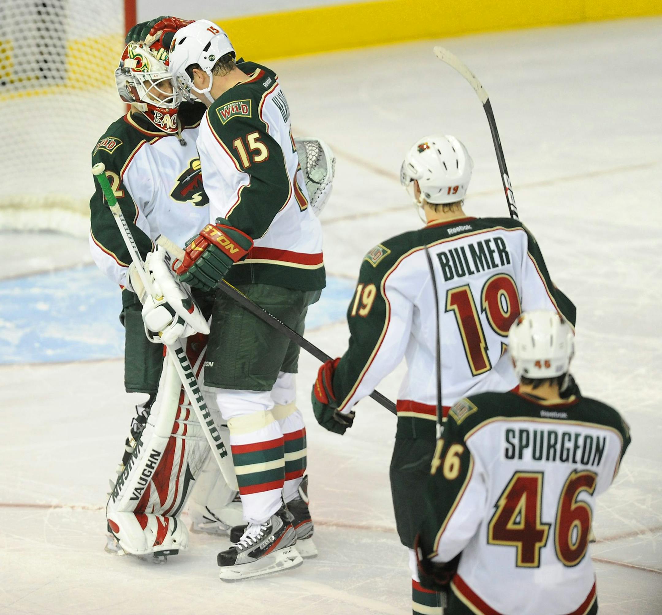 Minnesota Wild's Dany Heatley, 15, congratulates goalie Niklas Backstrom, left, following the overtime NHL hockey shootout win against the Edmonton Oilers in Edmonton on Thursday, Oct. 20, 2011. (AP Photo/The Canadian Press, John Ulan)