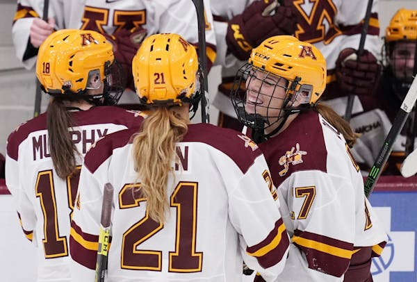 Gophers defenseman Josey Dunne (17) celebrated with forward Emily Oden (21) after she scored her first goal earlier this season.