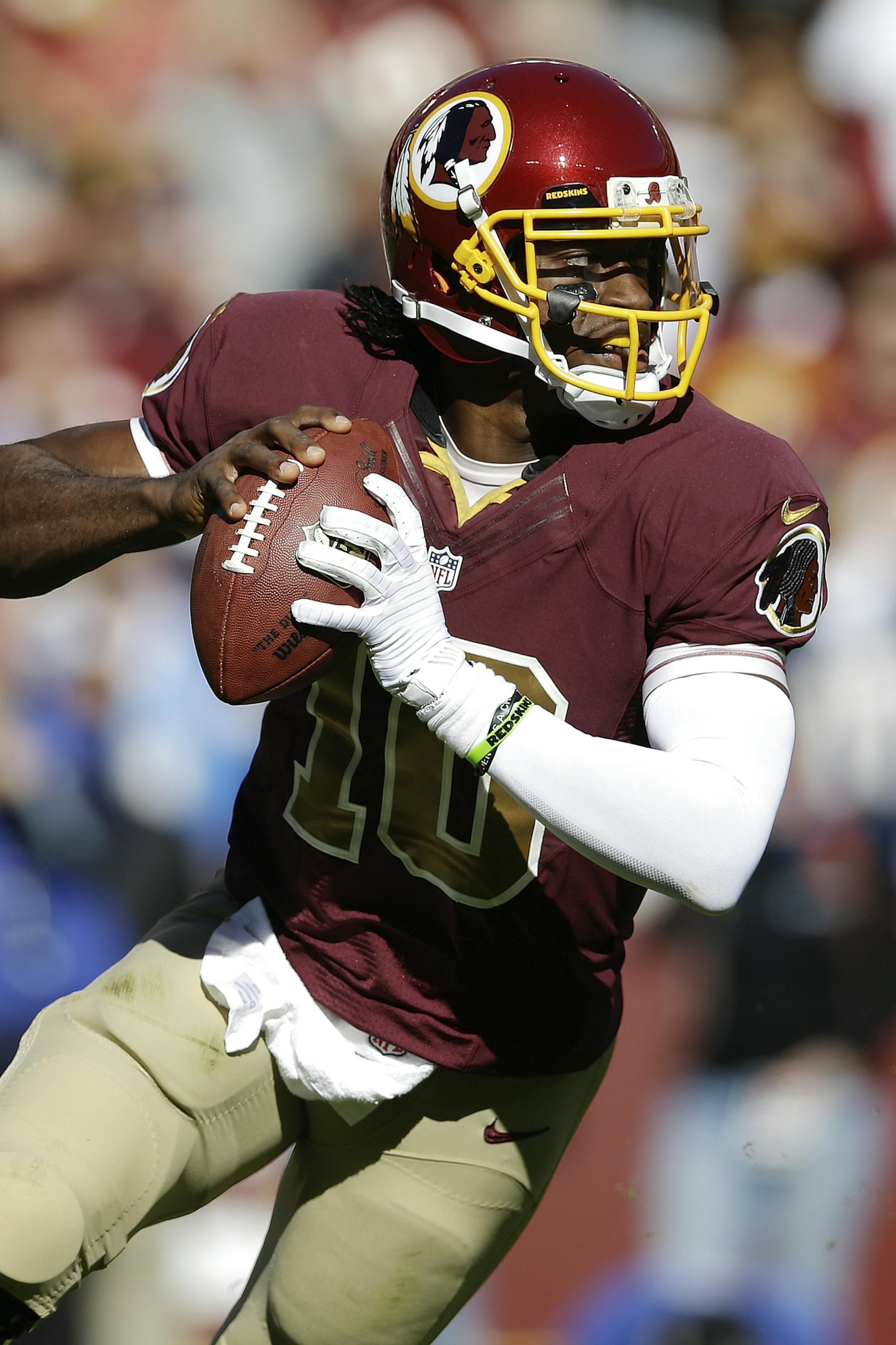 Washington Redskins quarterback Robert Griffin III scrambles with the ball during the first half of a NFL football game against the San Diego Chargers in Landover, Md., Sunday, Nov. 3, 2013. (AP Photo/Patrick Semansky)