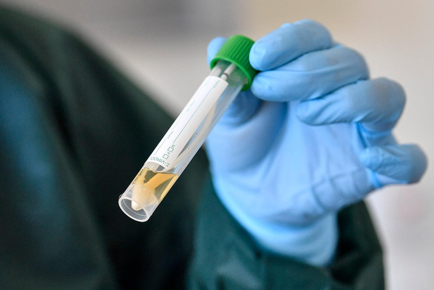 A nurse demonstrates taking a sample for a coronavirus test at the infection station of the university hospital in Essen, Germany, Thursday, March 12, 2020.