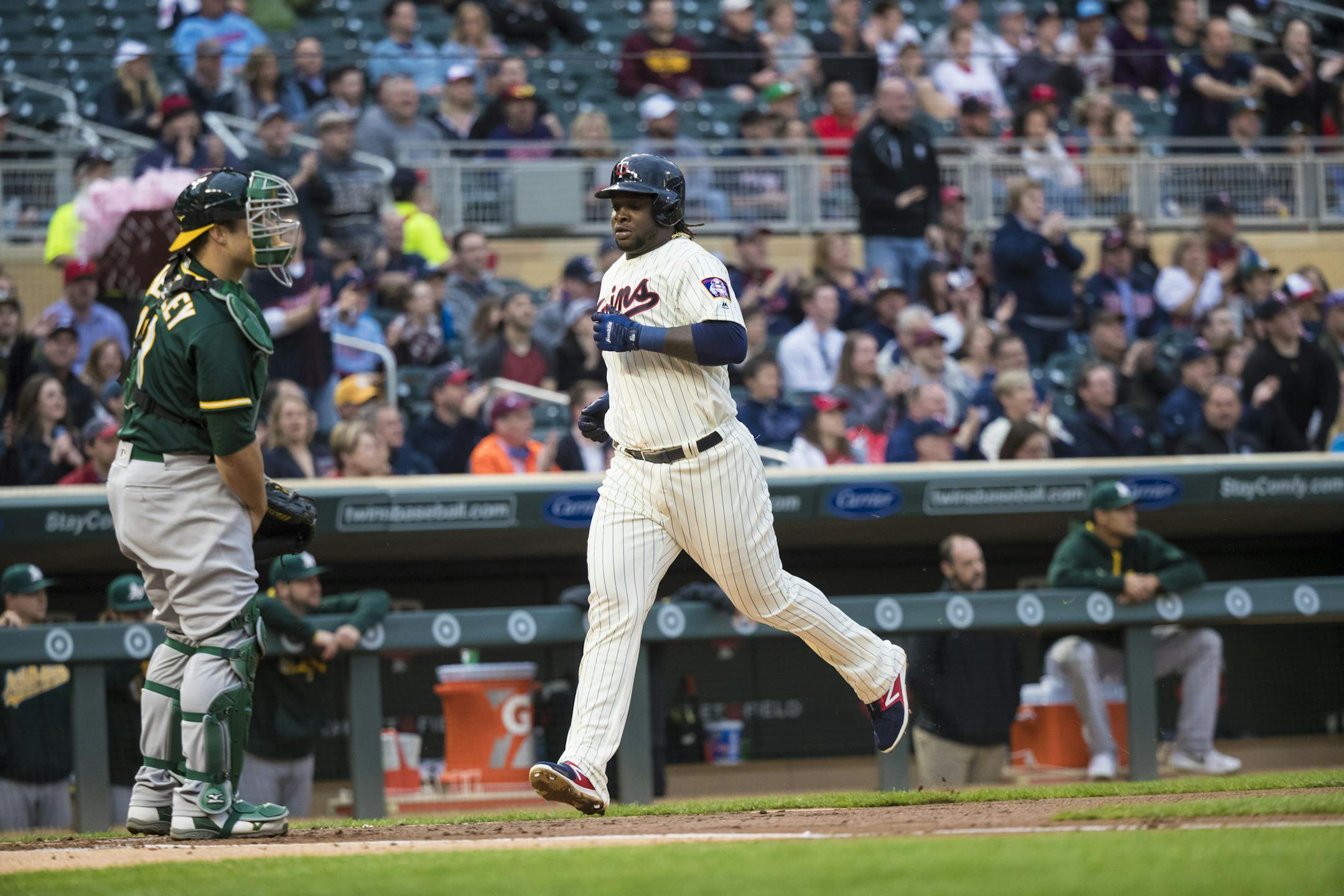Minnesota Twins third baseman Miguel Sano (22) scored on a single by Minnesota Twins first baseman Kennys Vargas (19) in the first inning. ] RENEE JONES SCHNEIDER • renee.jones@startribune.com The Oakland A's verses the Minnesota Twins at Target Field in Minneapolis, Minn., on Wednesday, May 3, 2017.