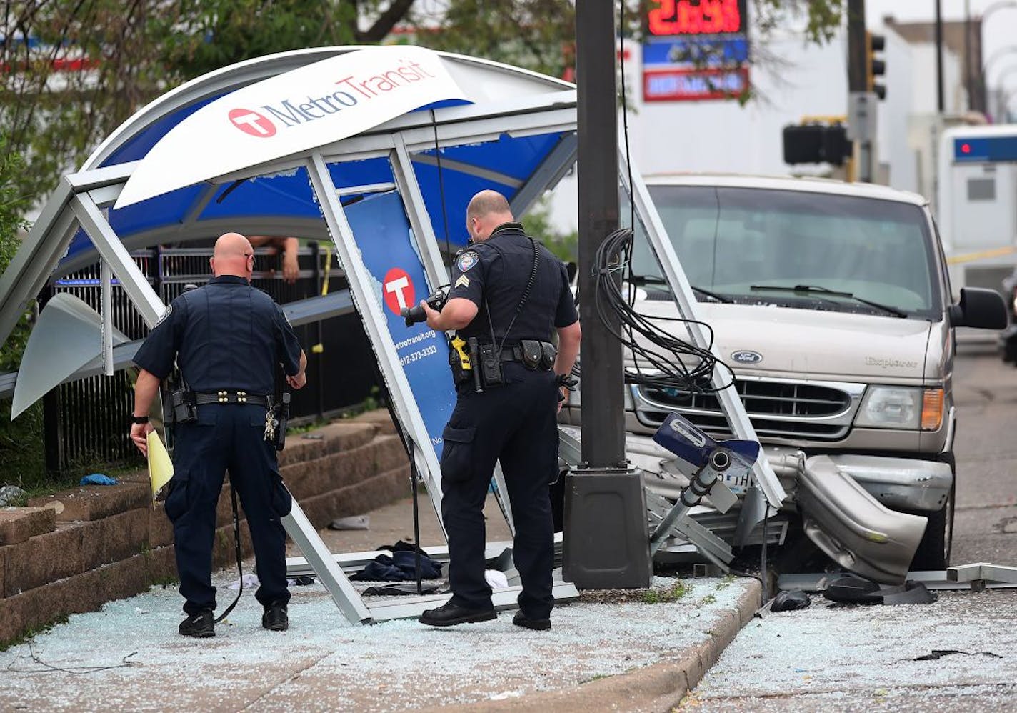 The scene where a van plowed into a bus shelter on Broadway Avenue N. near Lyndale Avenue, injuring several Tuesday, July 9, 2019, in Minneapolis, MN. Here, police investigate the scene.