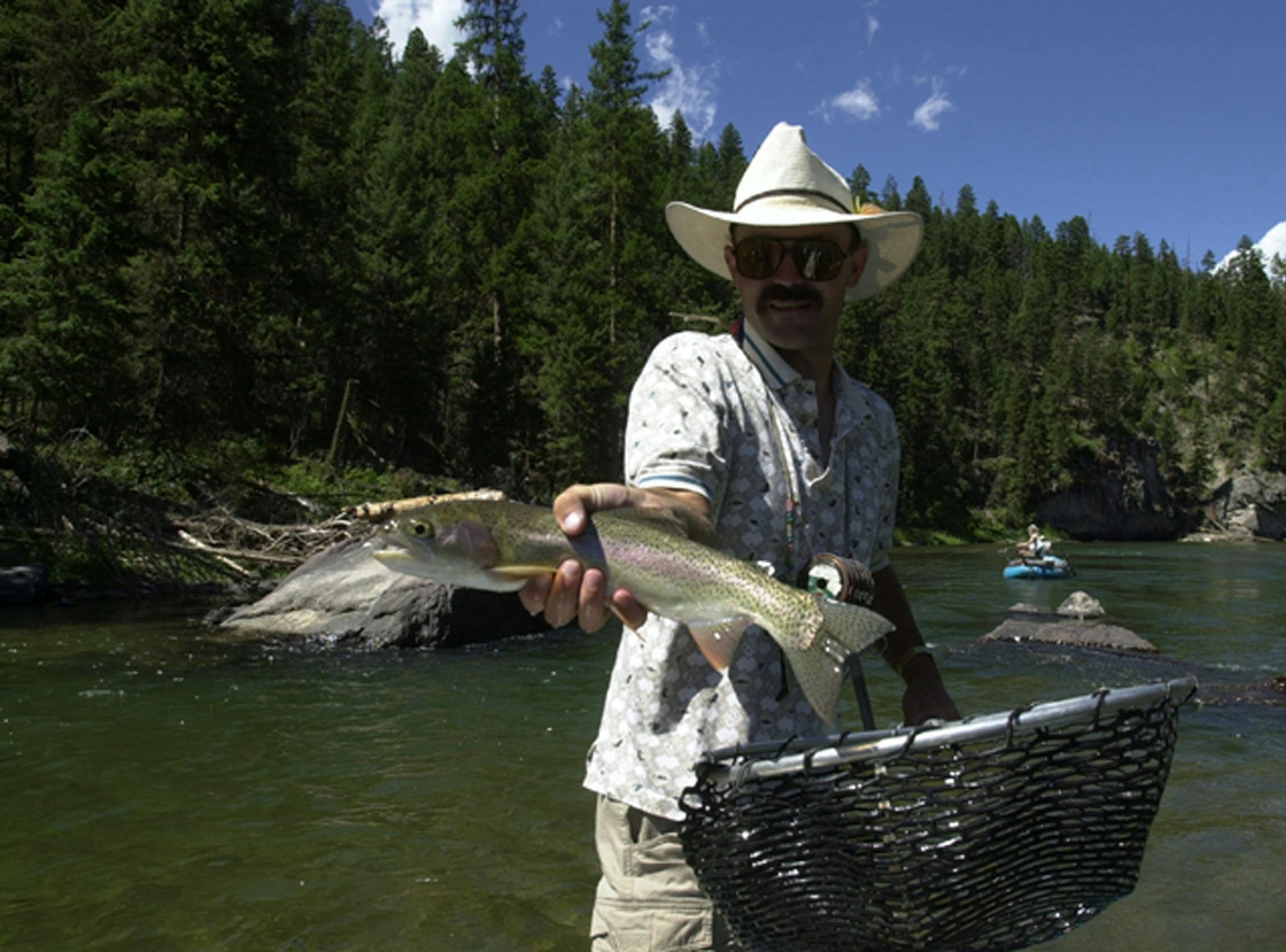 A Blackfoot River, Mont., fly fishing guide, Dave Clarke holds a dandy Rainbow trout.