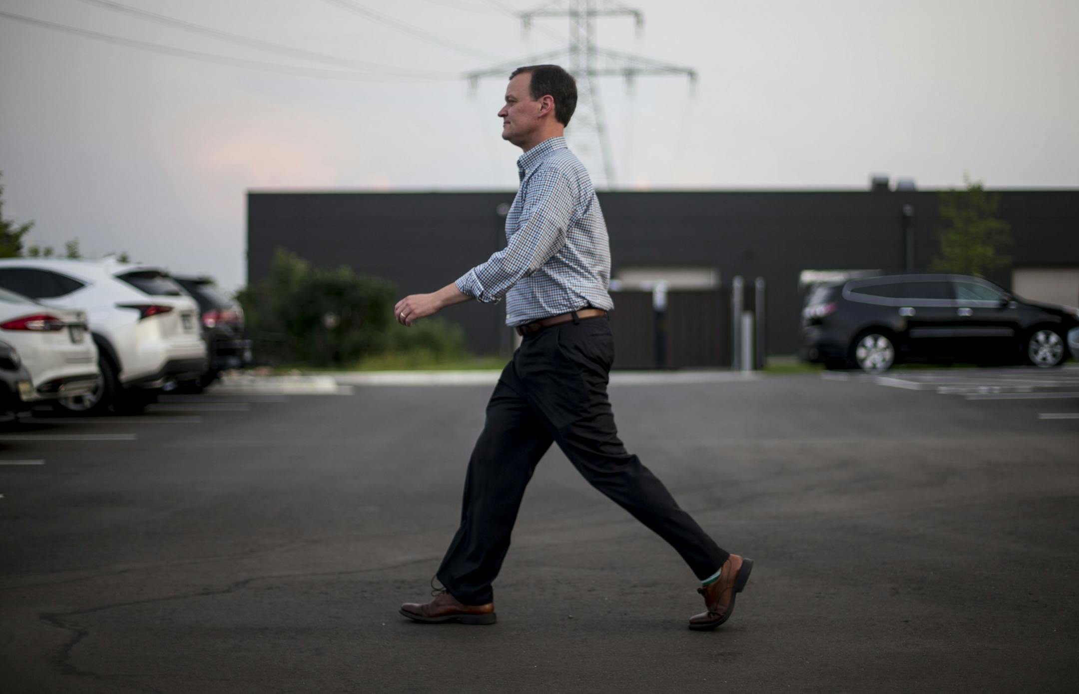 Republican Gubernatorial candidate, Jeff Johnson, walks to his car as he leaves the watch party to watch the first results in private.